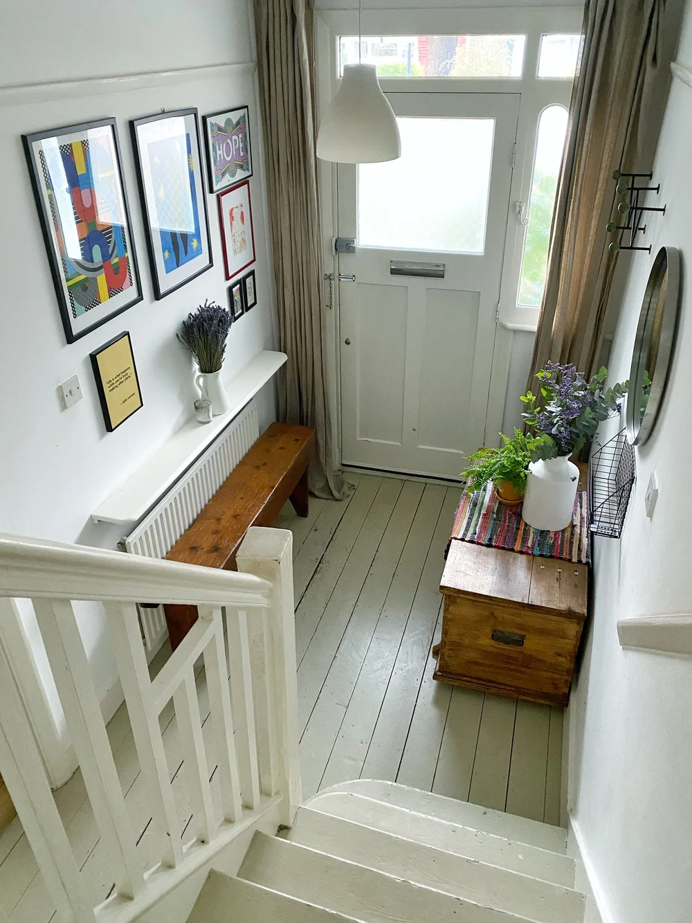 white-hallway-gallery-wall-and-bench