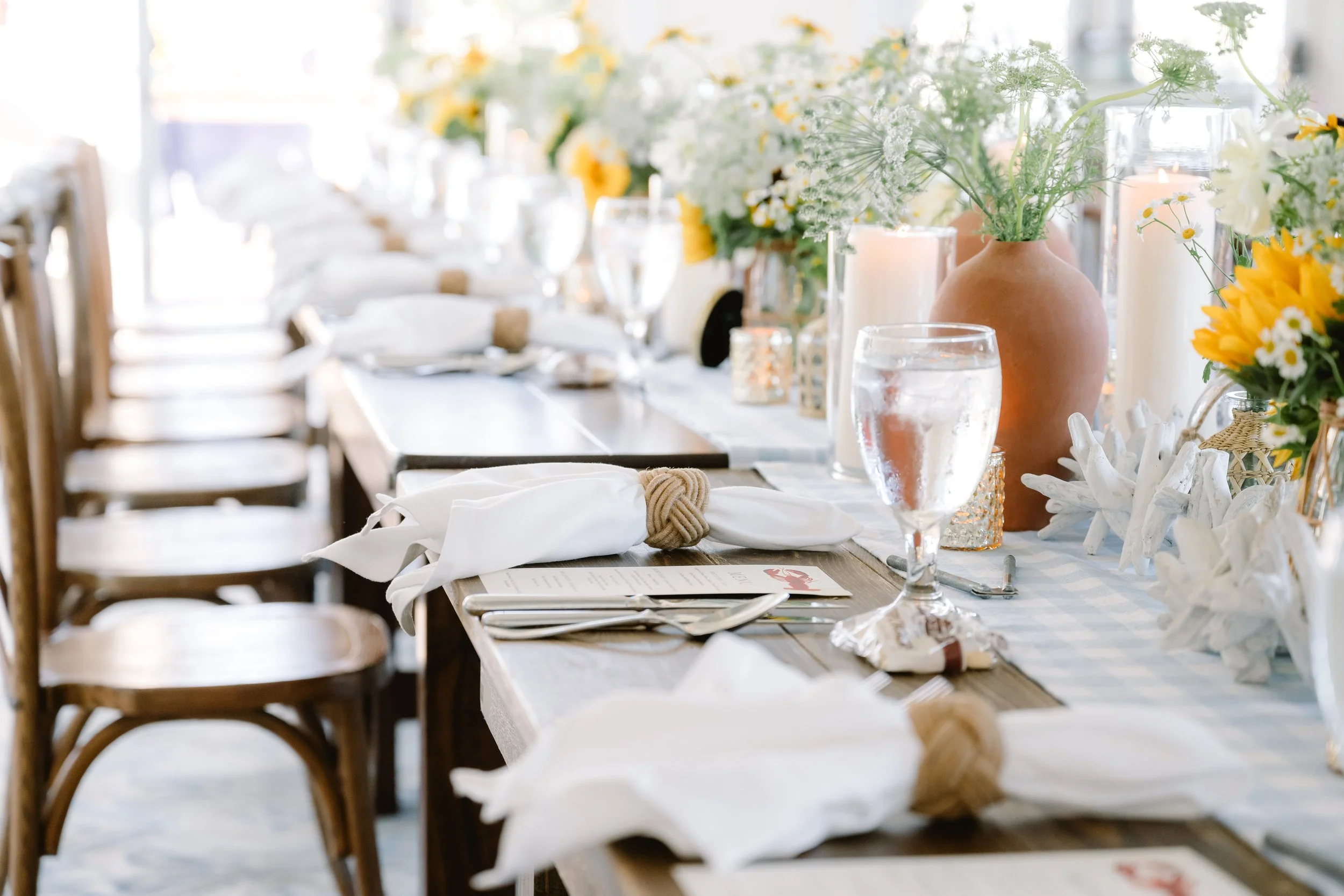 Elegant coastal wedding rehearsal dinner table setting
