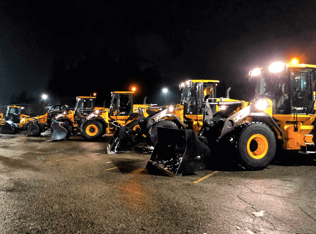 JCB Loader Line Up at Night with Buckets.png