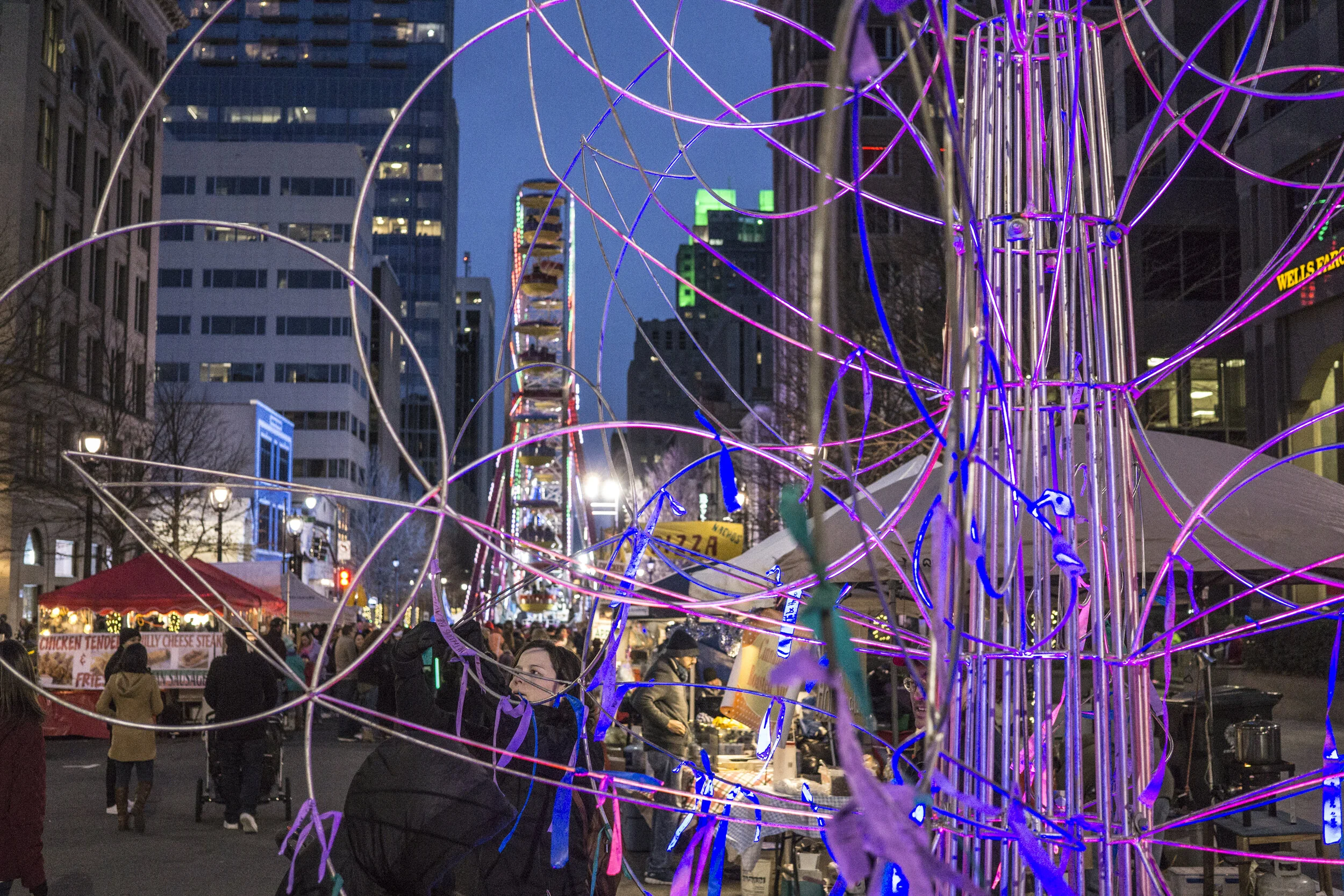 Night street view through purple loops of Resolution Oak tree on Fayetteville Street in downtown Raleigh, North Carolina at First Night Raleigh festival 