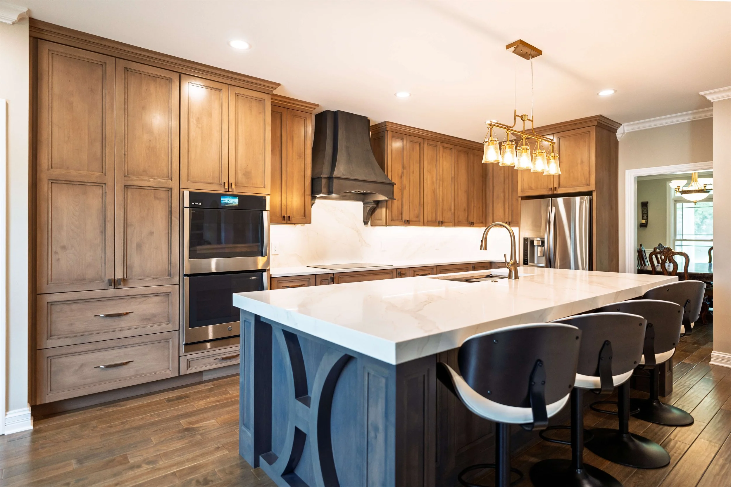 A Nashville, TN kitchen with a large island and stained cabinets.
