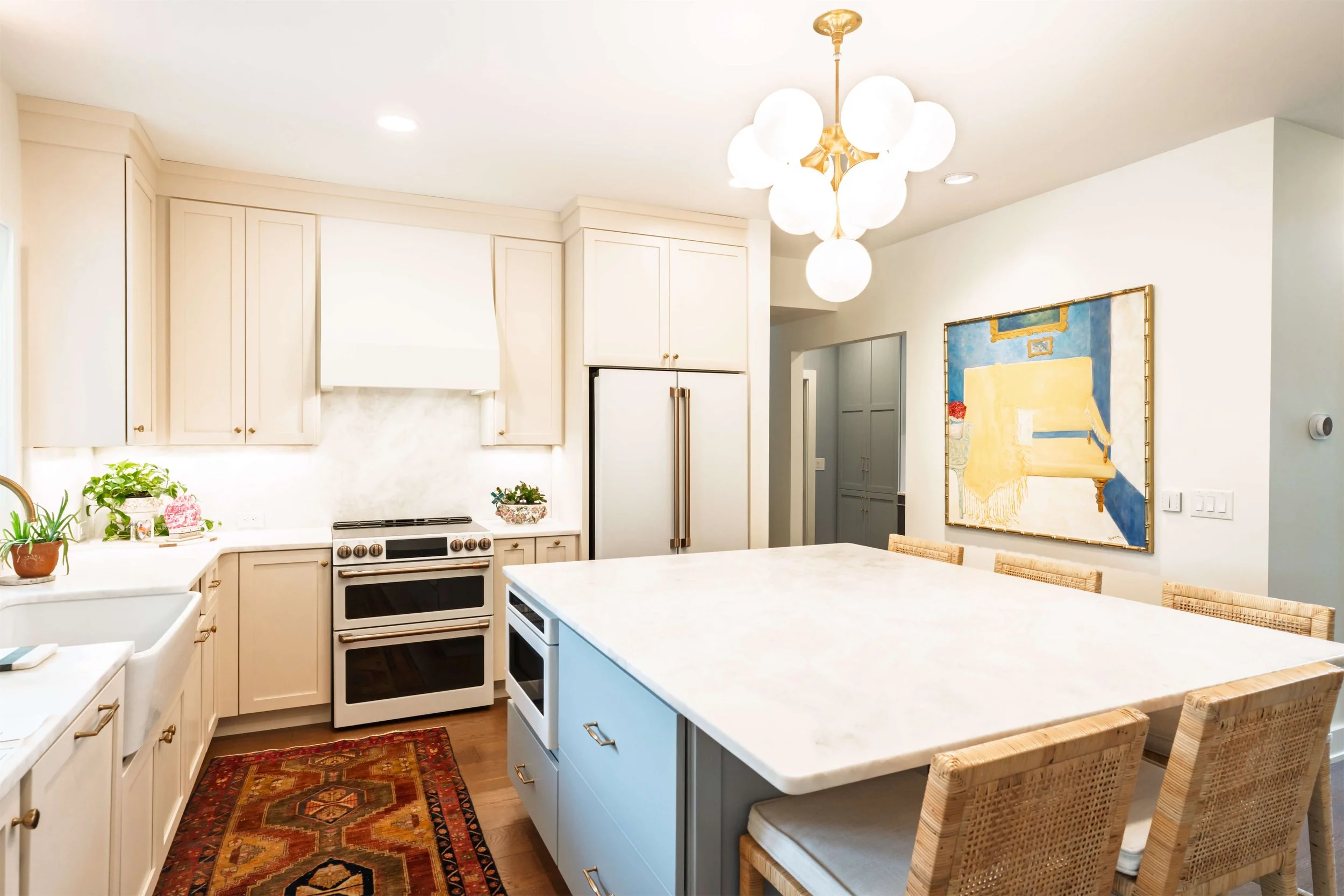 A Franklin, TN kitchen with creamy cabinets and an island with white marble.