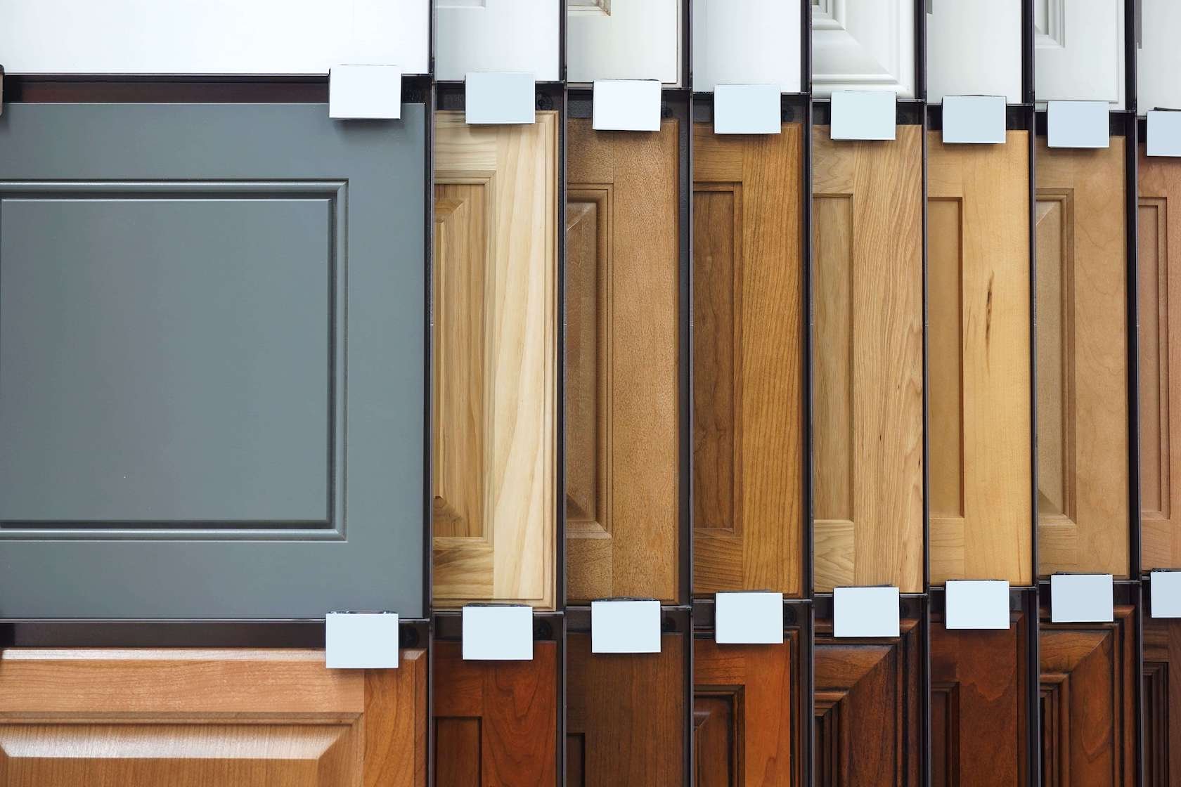 Various kitchen cabinet door samples in different wood finishes and colors