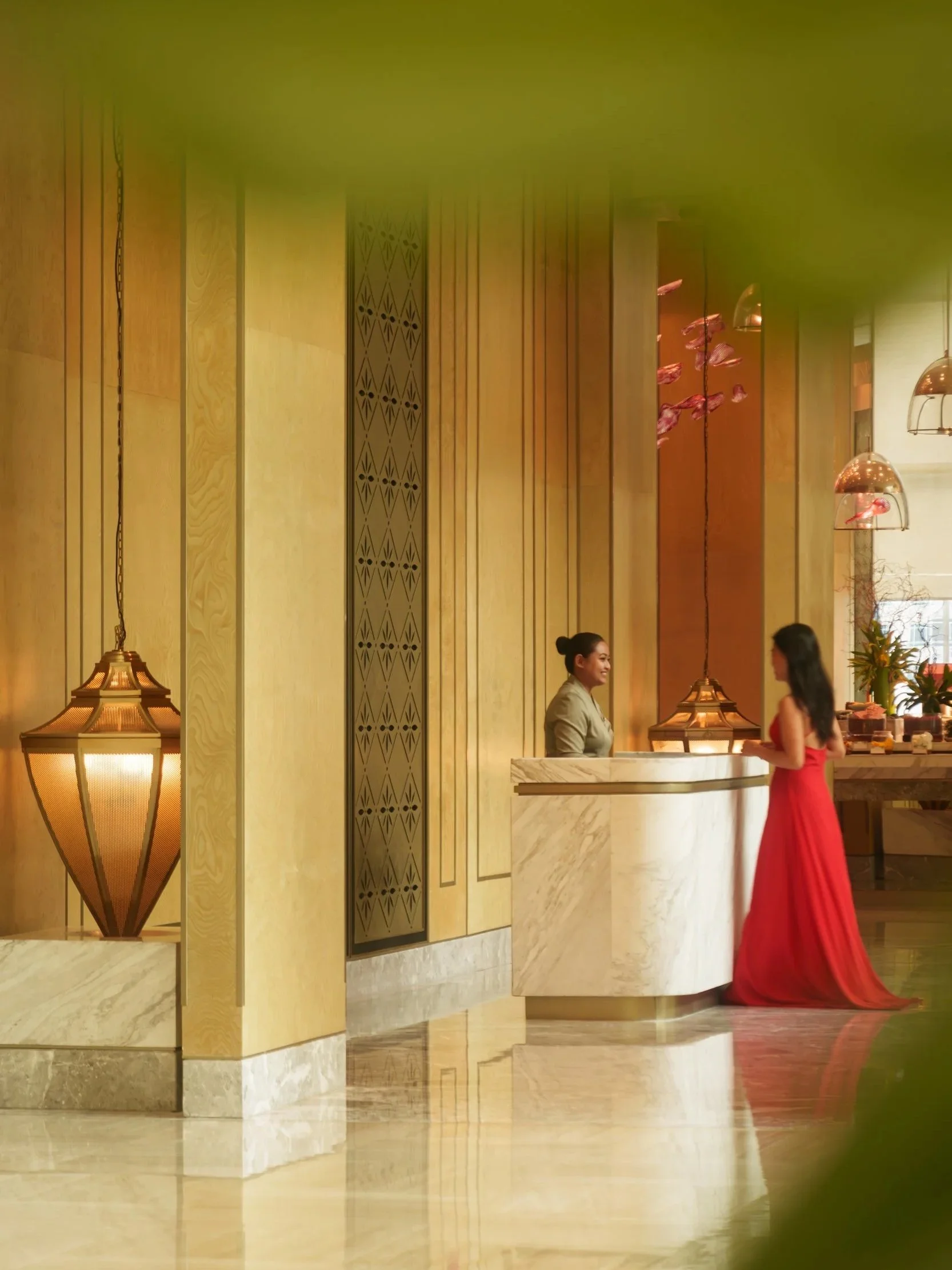 Luxurious hotel lobby interior featuring polished marble reception, elegant lighting fixtures, intricate wall details, and a sophisticated ambiance, beautifully captured by a London hospitality and architectural photographer.