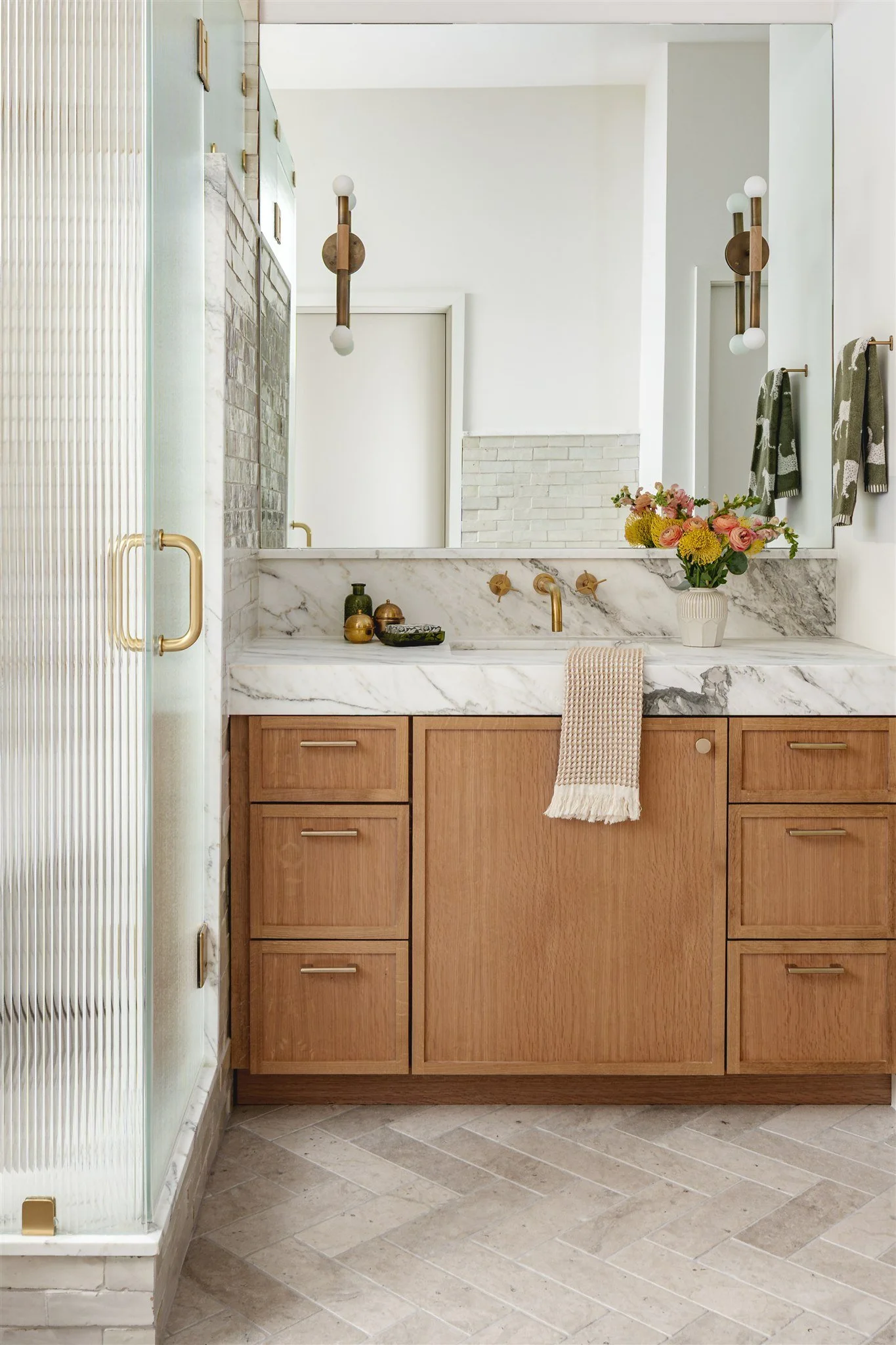 Calm, considered, and built to last. For our #Bellvue bathroom we kept the palette neutral and let the materials do the work &mdash; marble, limestone flooring, white oak cabinets, and unlacquered brass. Simple choices, executed well. The kind of roo