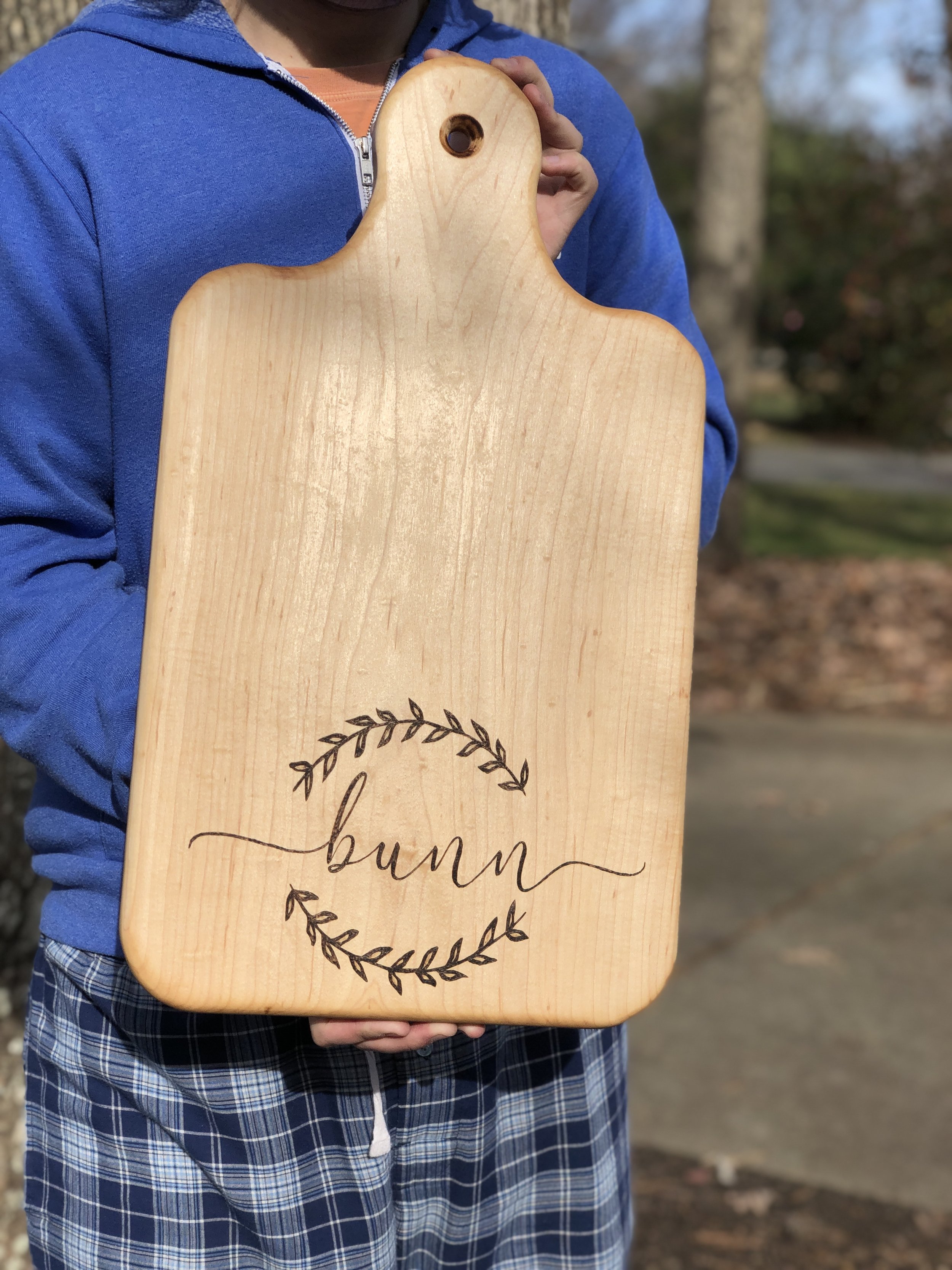 Custom wood-burned and cut maple charcuterie board.