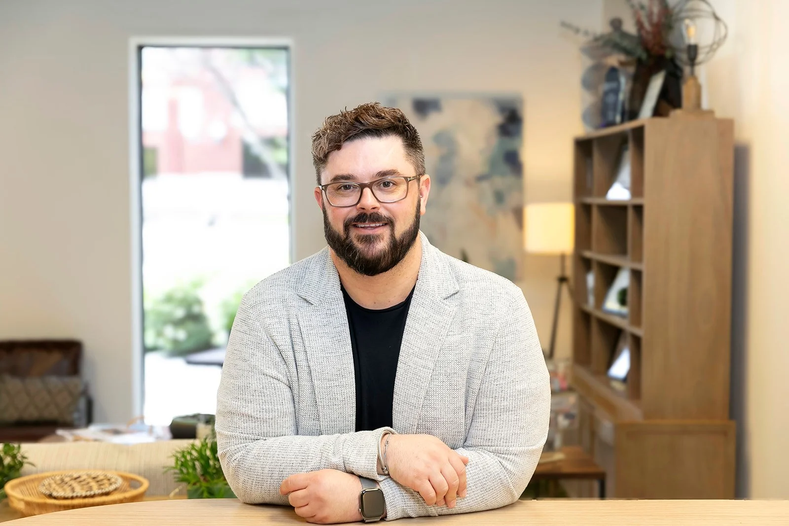 Hutch Ice smiling and leaning on desk
