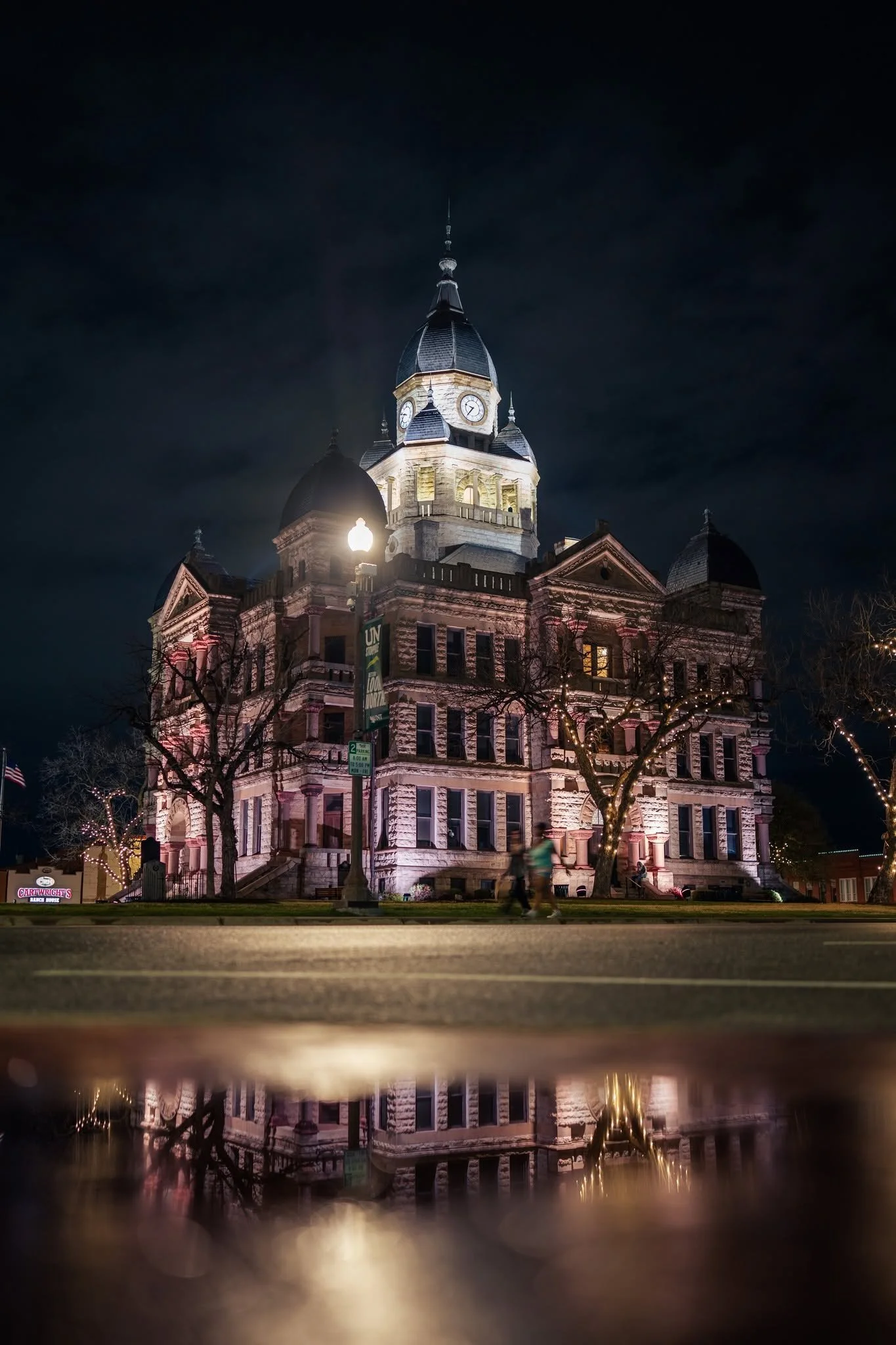 Denton courthouse at night with reflection in water