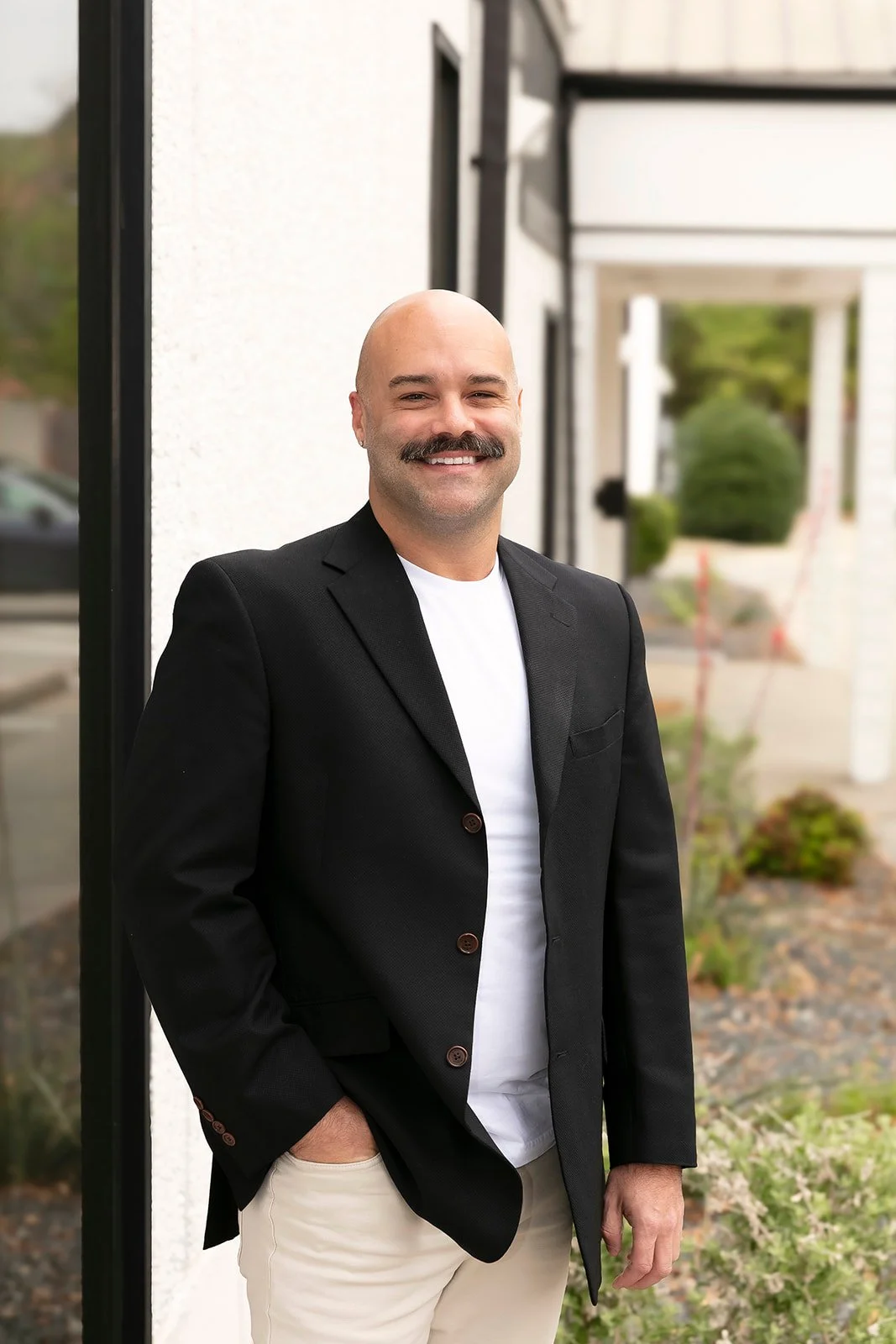 Rusty Stephenson smiling outside wearing a black jacket and white shirt