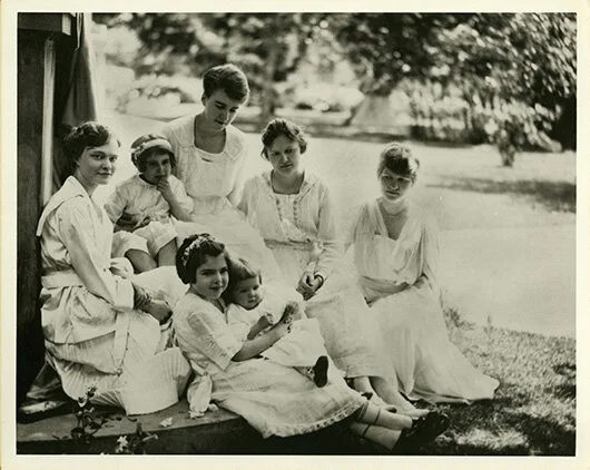 Left to right: Elisabeth, Adelia “Diggie,” Margaret, Helen, Lucy; Rosemary holding Janice seated in front.