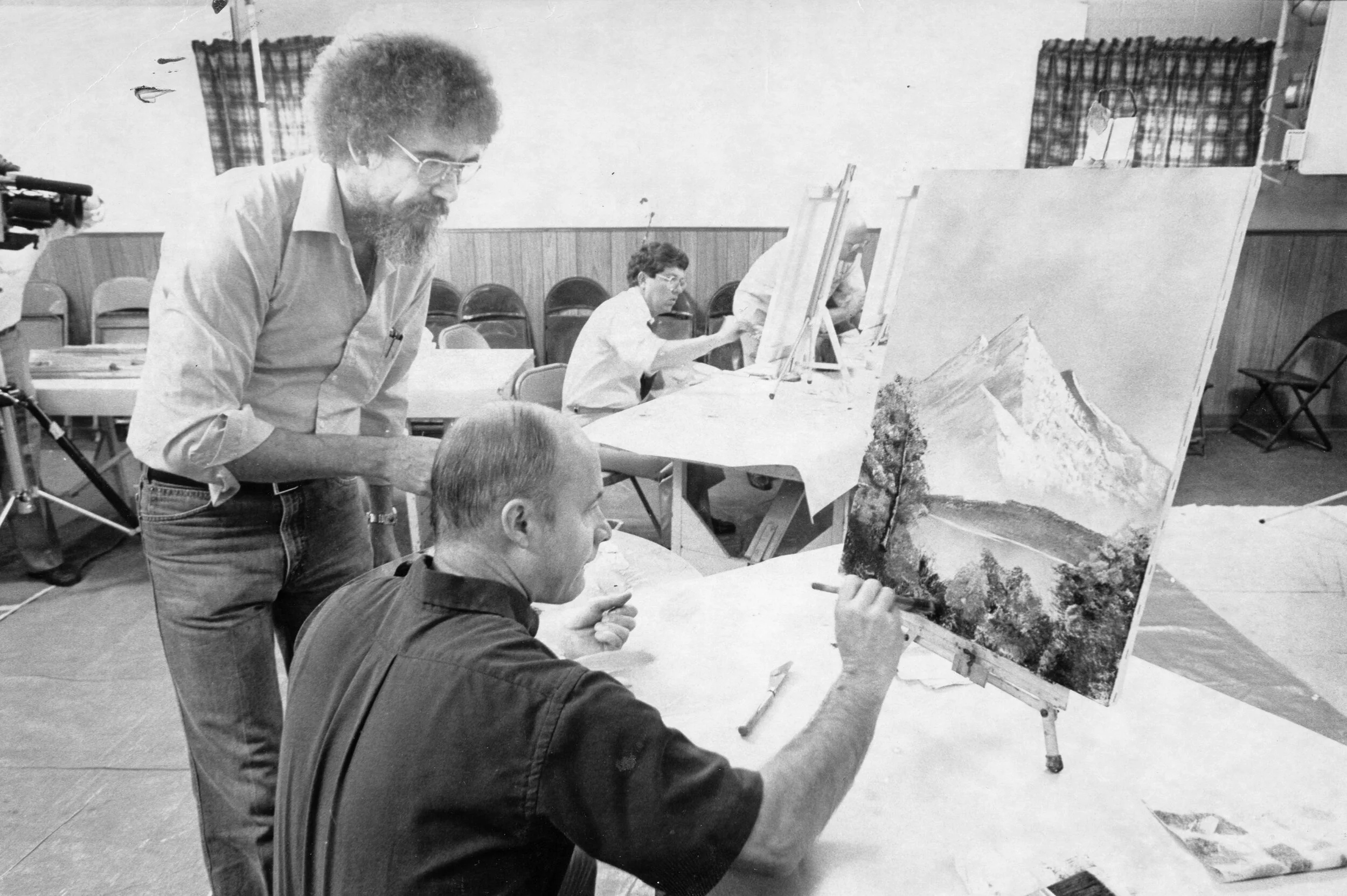 Rare archival photograph of Bob Ross guiding a student during a 1983 public television fundraising painting demonstration