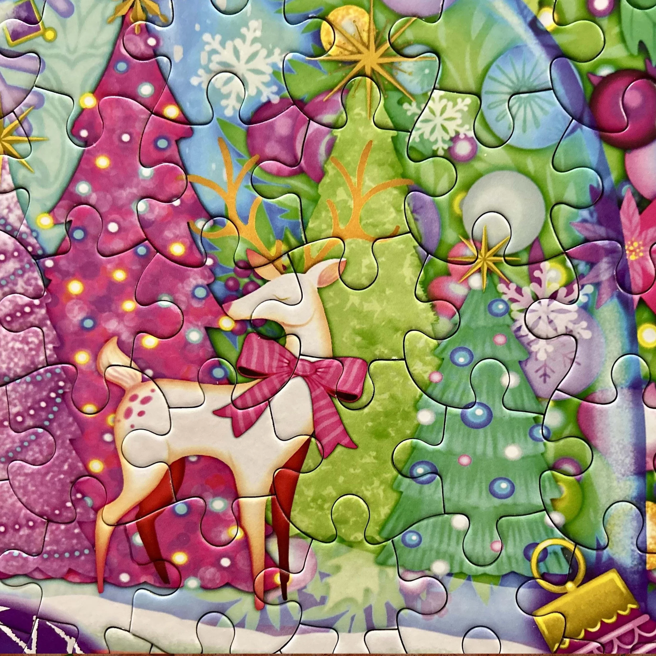 Colorful puzzle featuring Christmas-themed decorations, including snowflakes, stars, ribbons, and a green tree with ornaments.