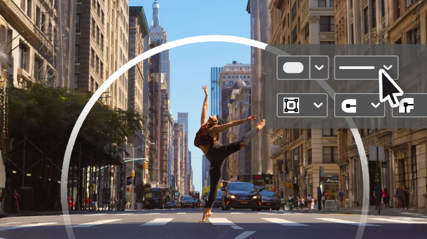 A woman dancing barefoot in the middle of a city street with tall buildings on both sides, some people and cars in the background, and a clear blue sky.