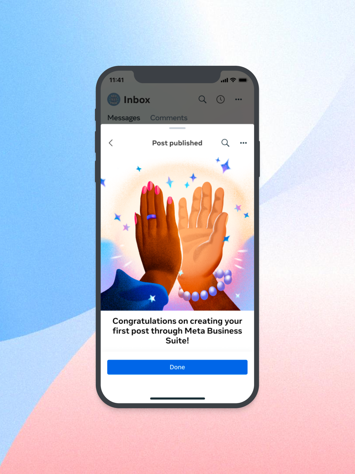 Smartphone screen displaying a congratulatory message for creating a first post on Meta Business Suite, with an illustration of two hands high-fiving.