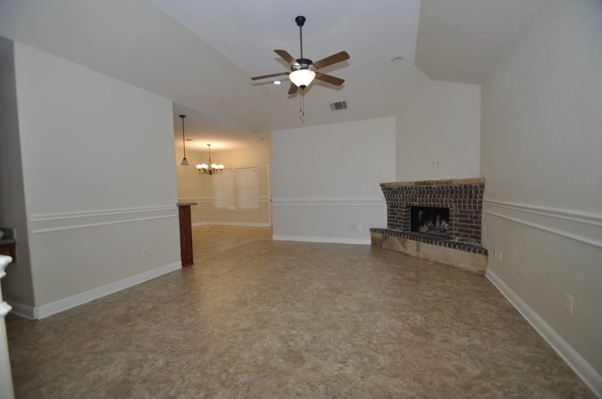 Living room, 10 to 12 ft ceiling and wood burning fireplace