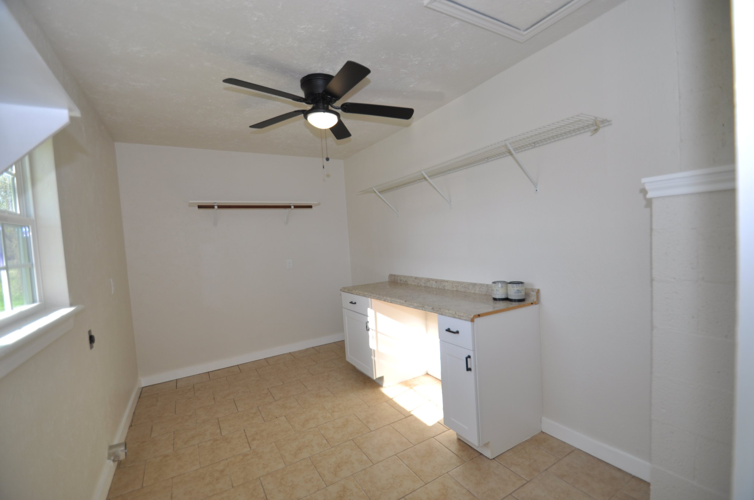Large utility room with electric washer and dryer connections.