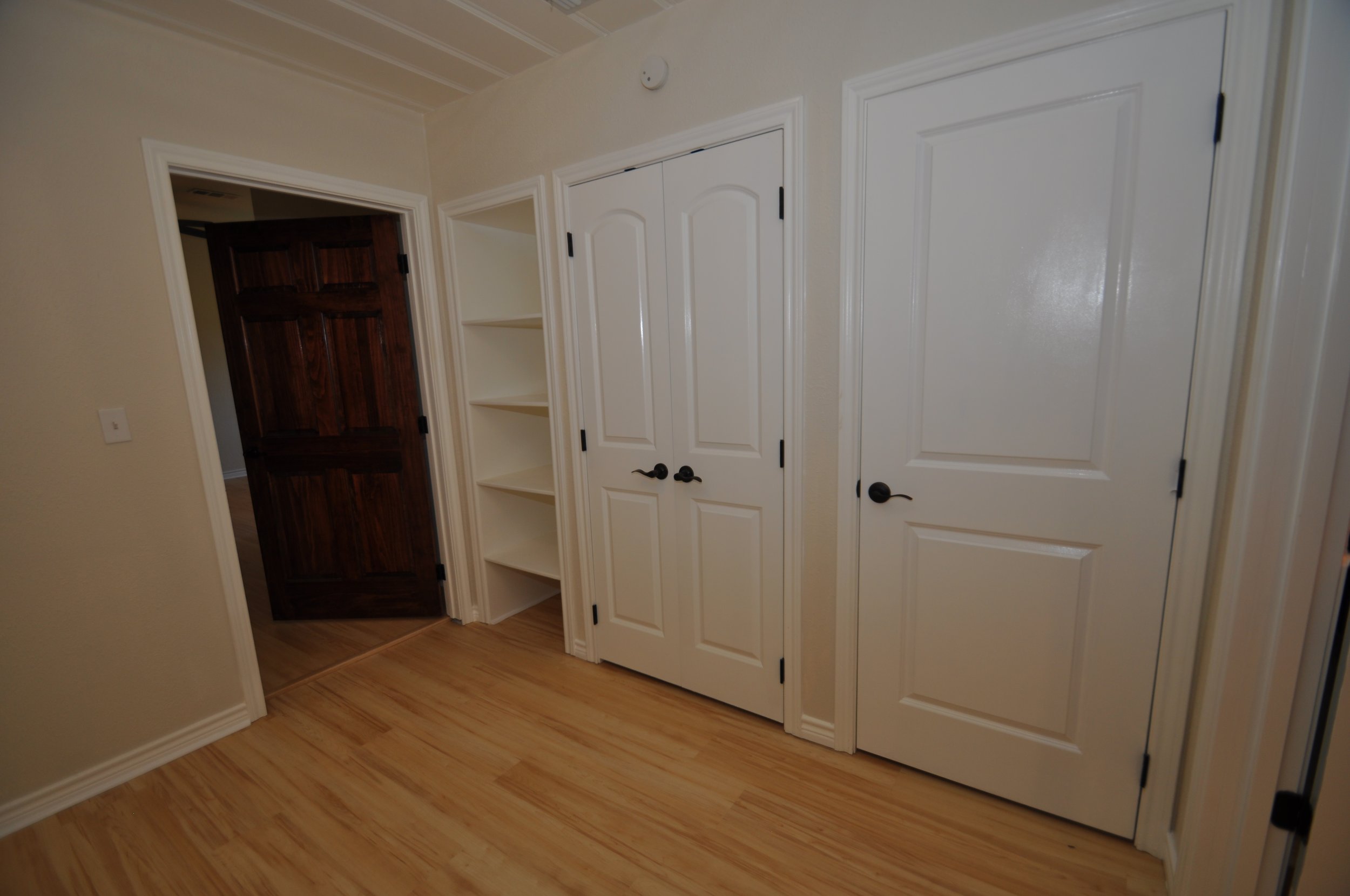 Solid vintage wood door to the master bedroom, on the left of pic.