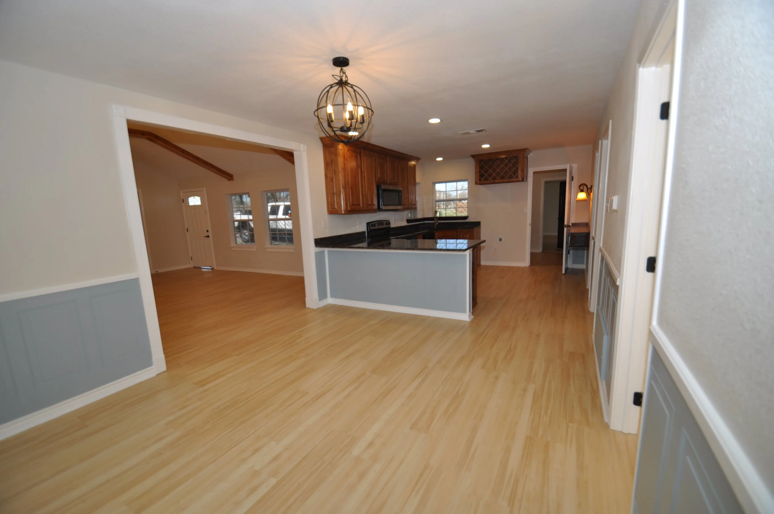 Kitchen from dining area. Beautiful design and wear resistant wainscotting. 