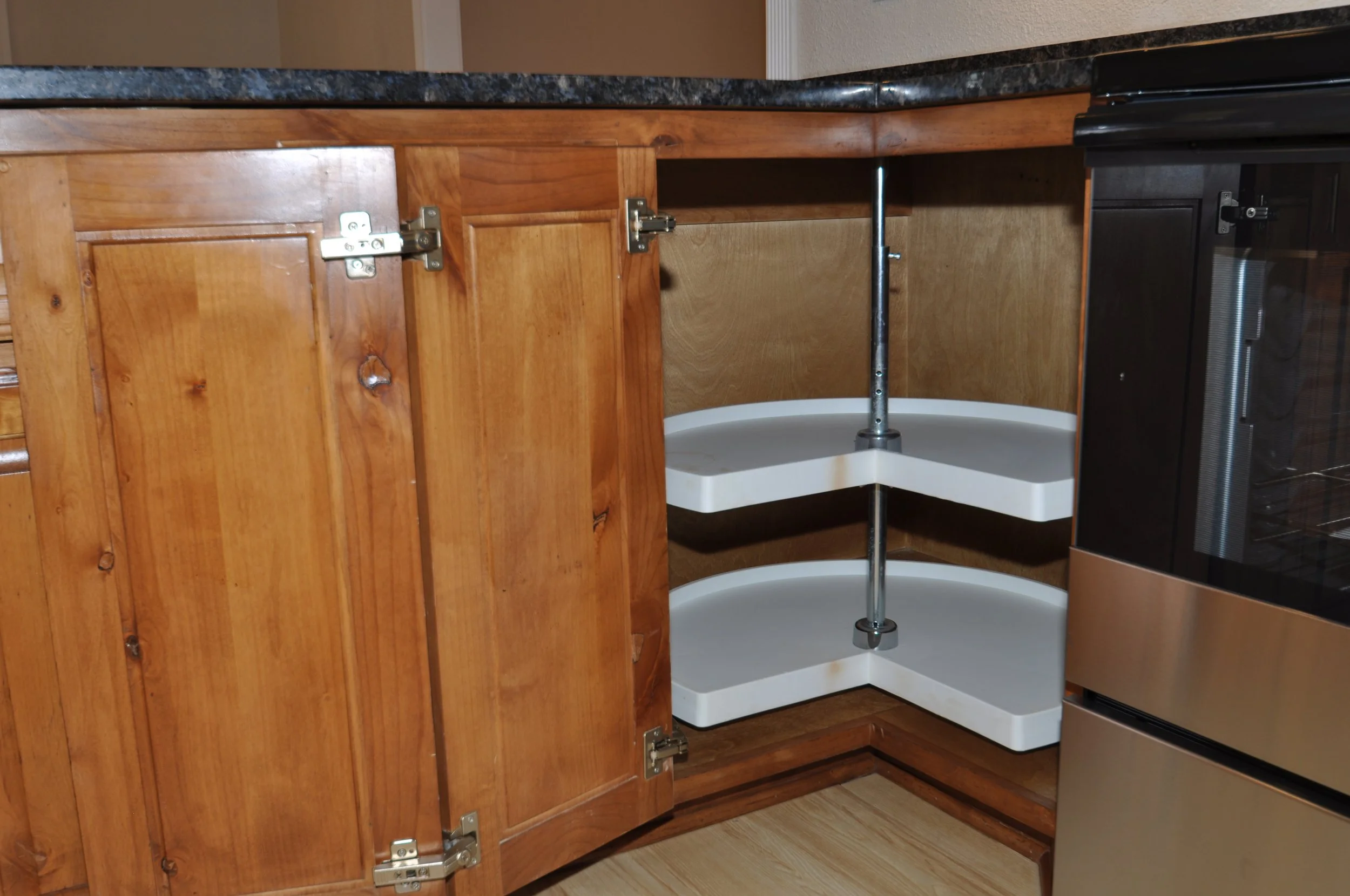Corner of base cabinets showing full size 'lazy-susan', with 270 degree opening hinge.  Most builders do not provide this convenience.