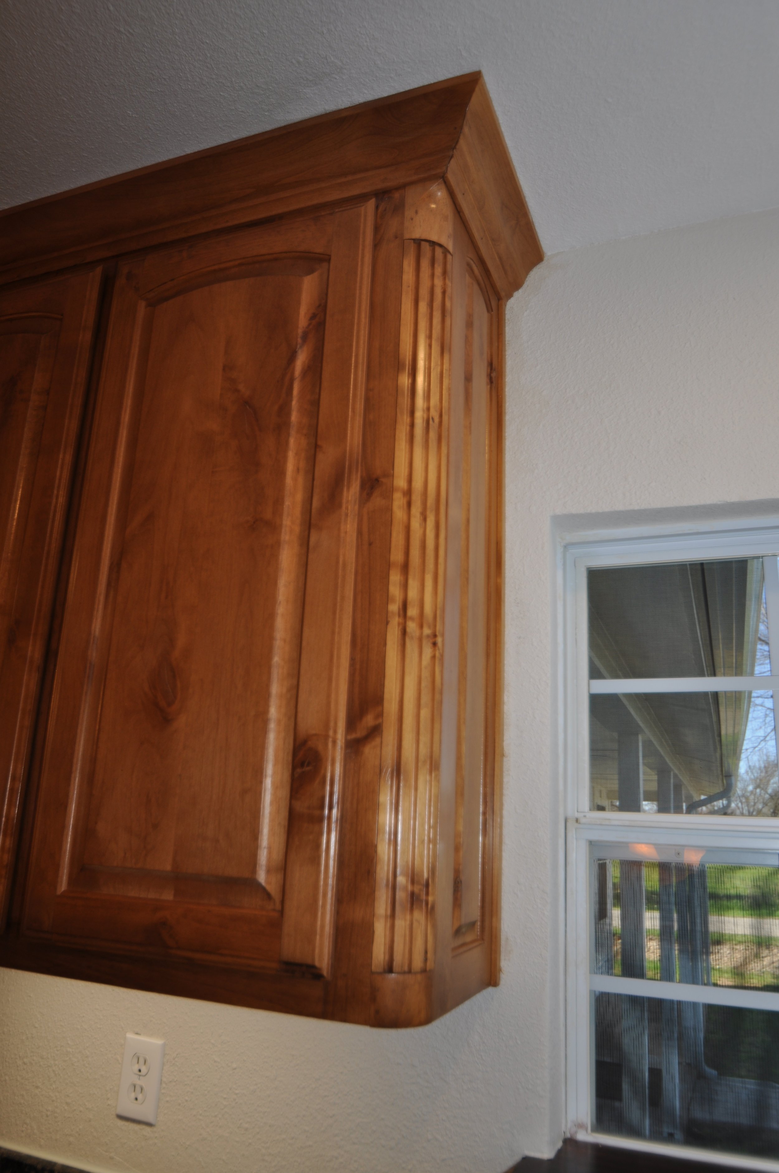 Detail showing some of the quality and detail of cabinet construction. Raised panels, detailed rounded corners and crown molding.