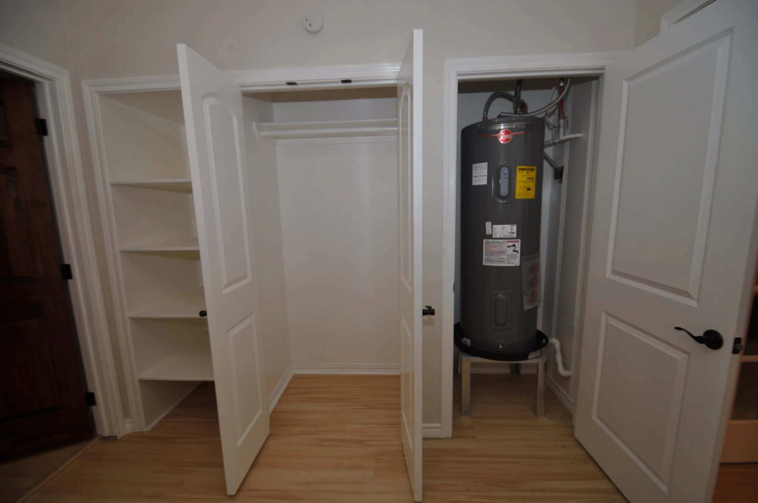More storage shelves and hanging closet. Note the new water heater.