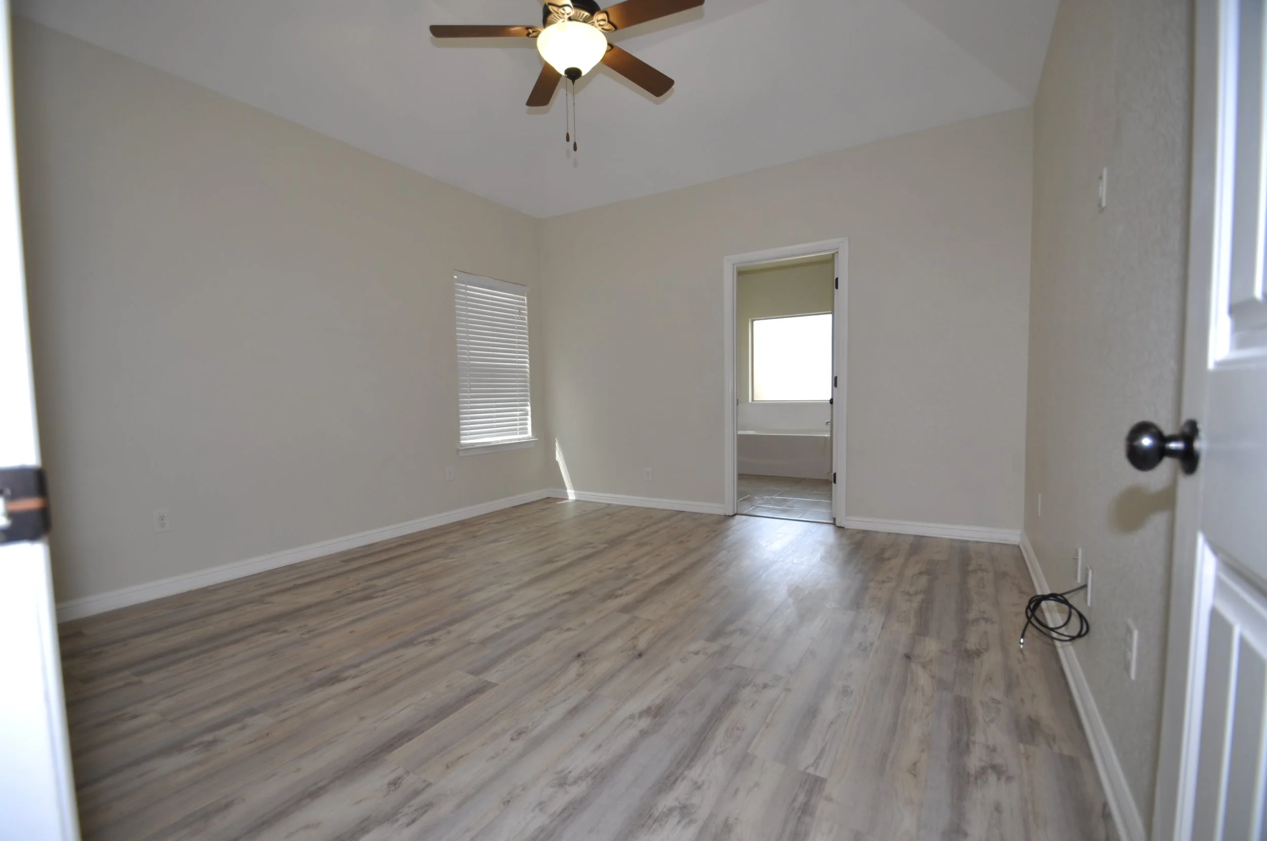 Master bedroom with luxury vinyl plank flooring for low maintenance 