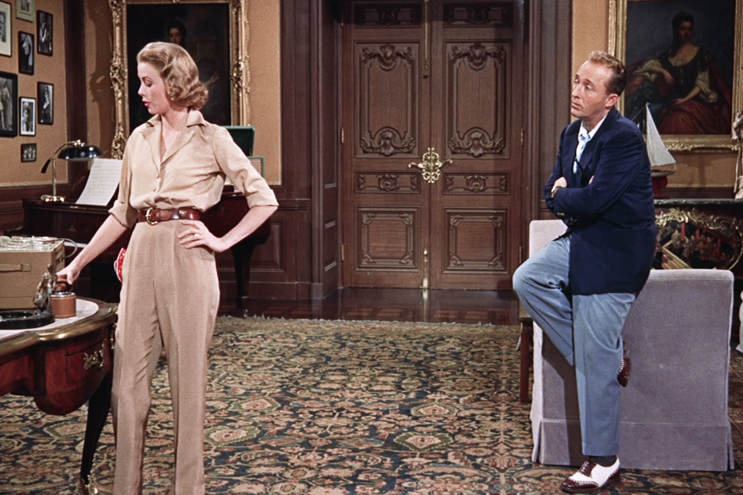 Grace Kelly wearing a blouse tucked into high-waisted pants in High Society