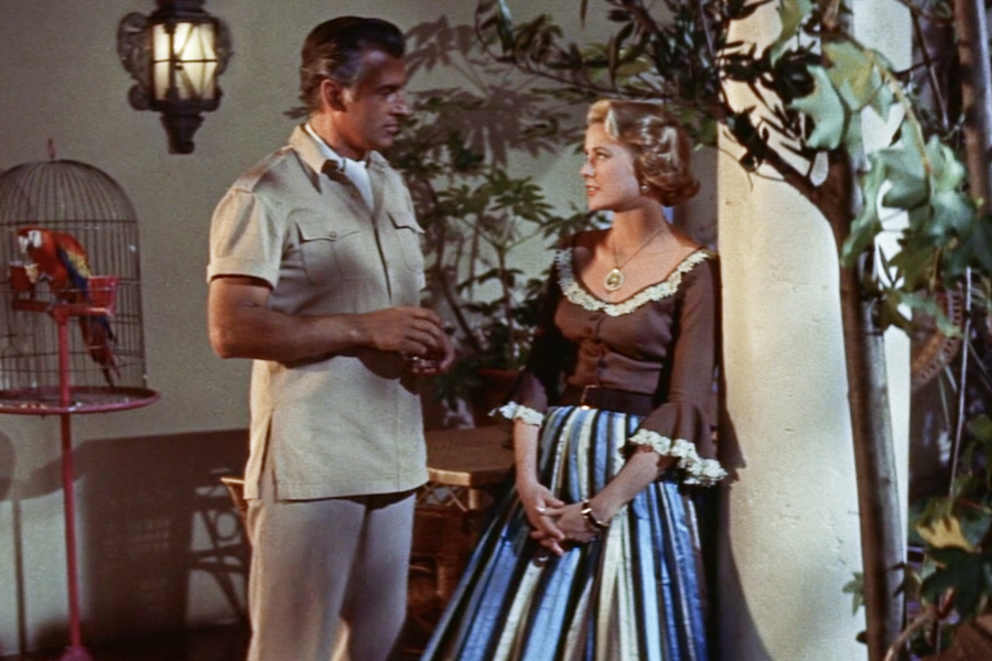 Again, Grace Kelly’s 1950s fashion choice is a full skirt, a blouse, and a belt emphasizing the waist.