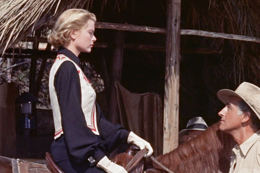 Grace Kelly style equestrian varies a bit from her earlier fashions. It’s not often you see Grace Kelly wearing an embroidered vest. The white gloves look like her style though.