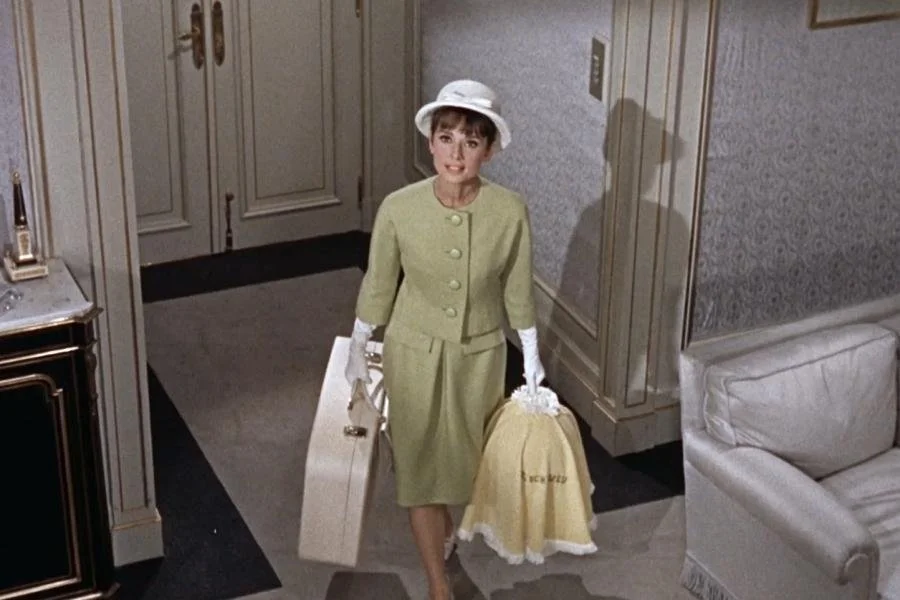 Audrey Hepburn wearing a green givenchy suit in Paris when it sizzles