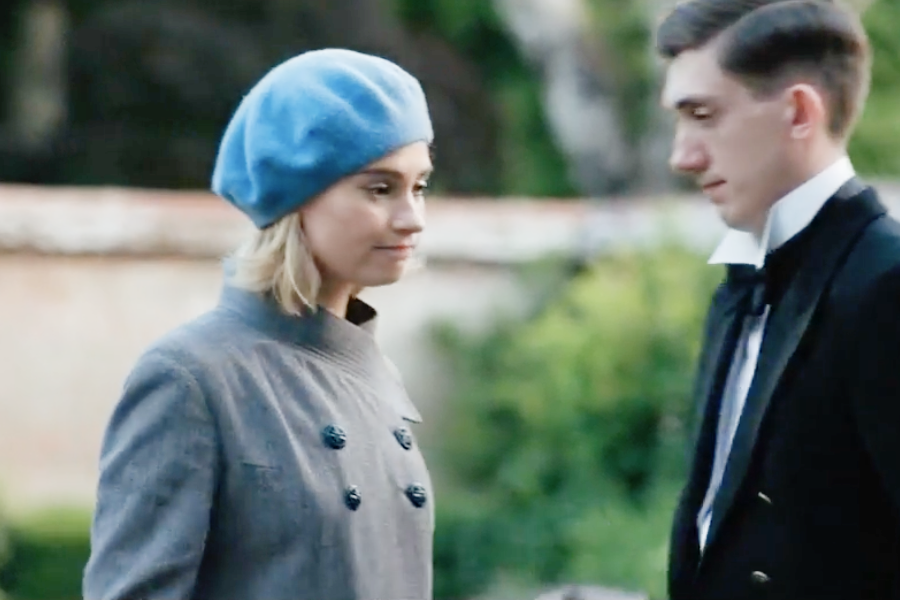 Image of Lily James wearing a 1930s coat and hat in the movie "Rebecca"