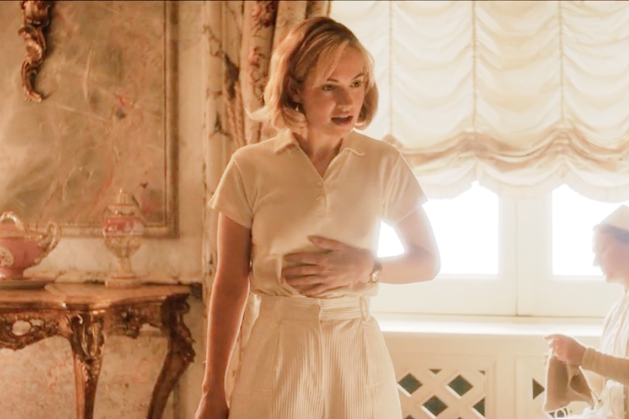 Image of Lily James wearing a 1930s shirt and shorts in the movie "Rebecca"
