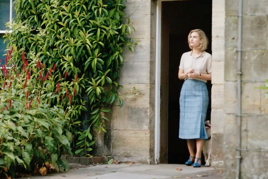 Image of Lily James wearing a 1930s blouse and skirt in the movie "Rebecca"