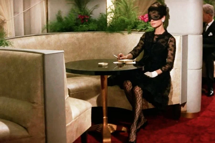 Audrey Hepburn wearing a black dress in How to Steal a Million
