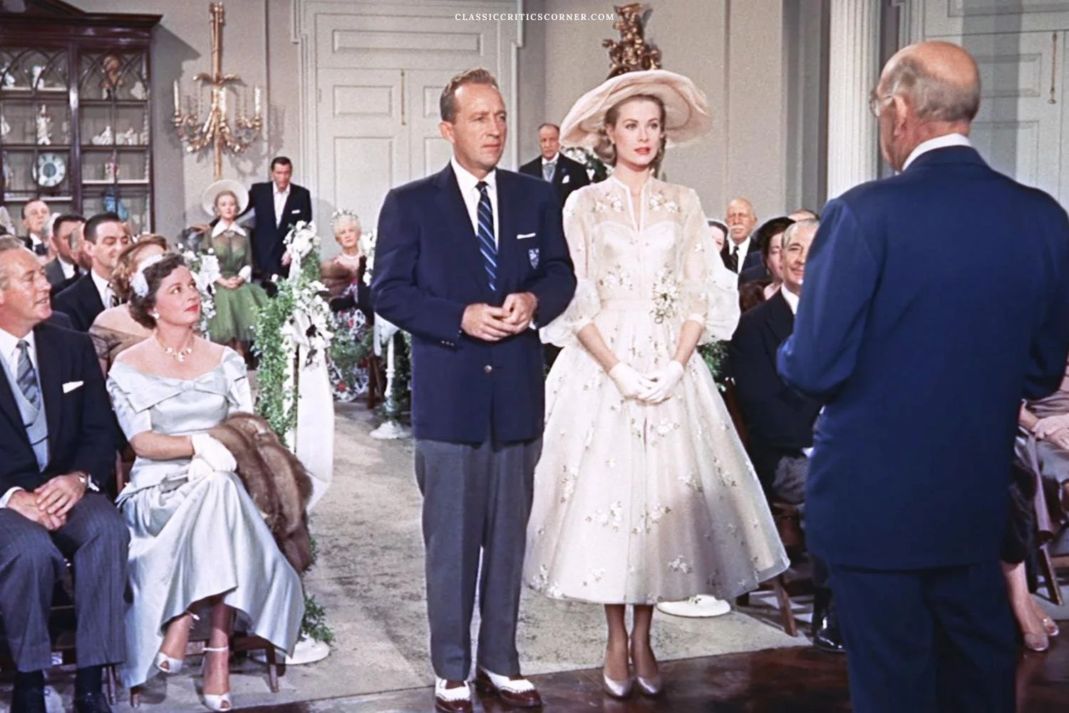 Image of Grace Kelly in a wedding dress standing next to Bing Crosby from the movie High Society
