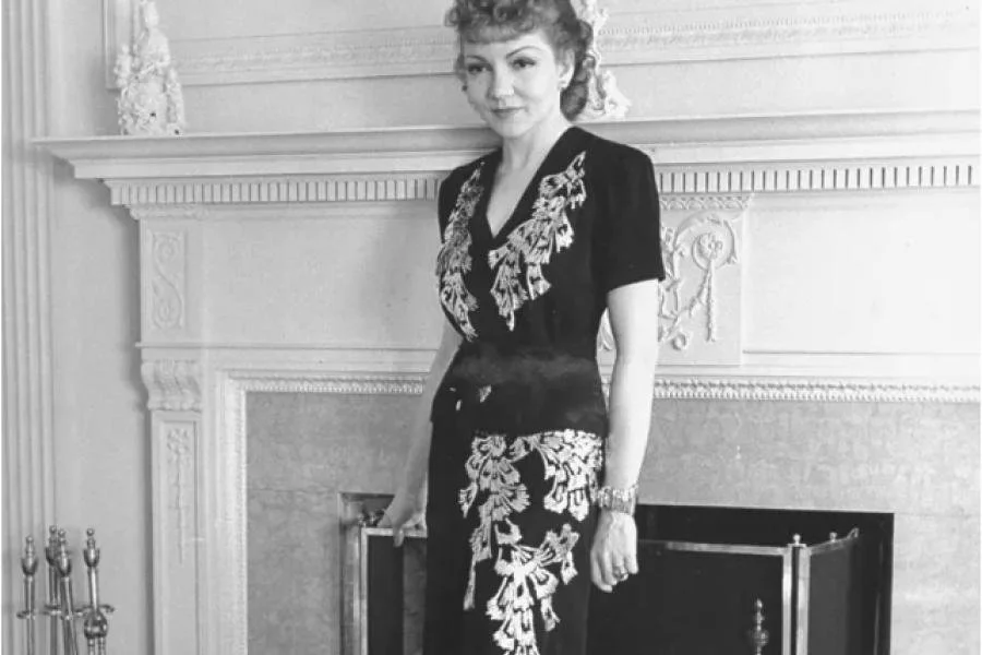 Image of Claudette Colbert wearing a two piece evening gown in the 1930s