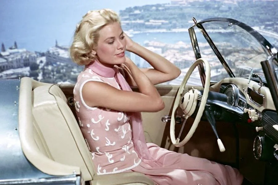 image of grace kelly wearing a pink dress and a scarf