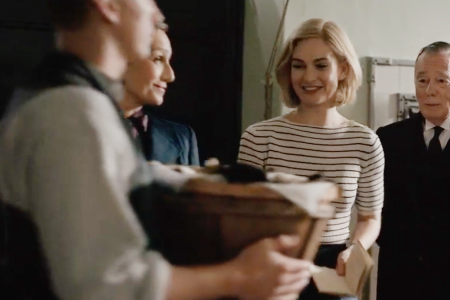Image of Lily James wearing a 1930s striped blouse and pants in the movie "Rebecca"