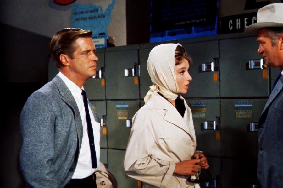 audrey hepburn wearing a tan trenchcoat with matching head scarf in Breakfast at Tiffanys