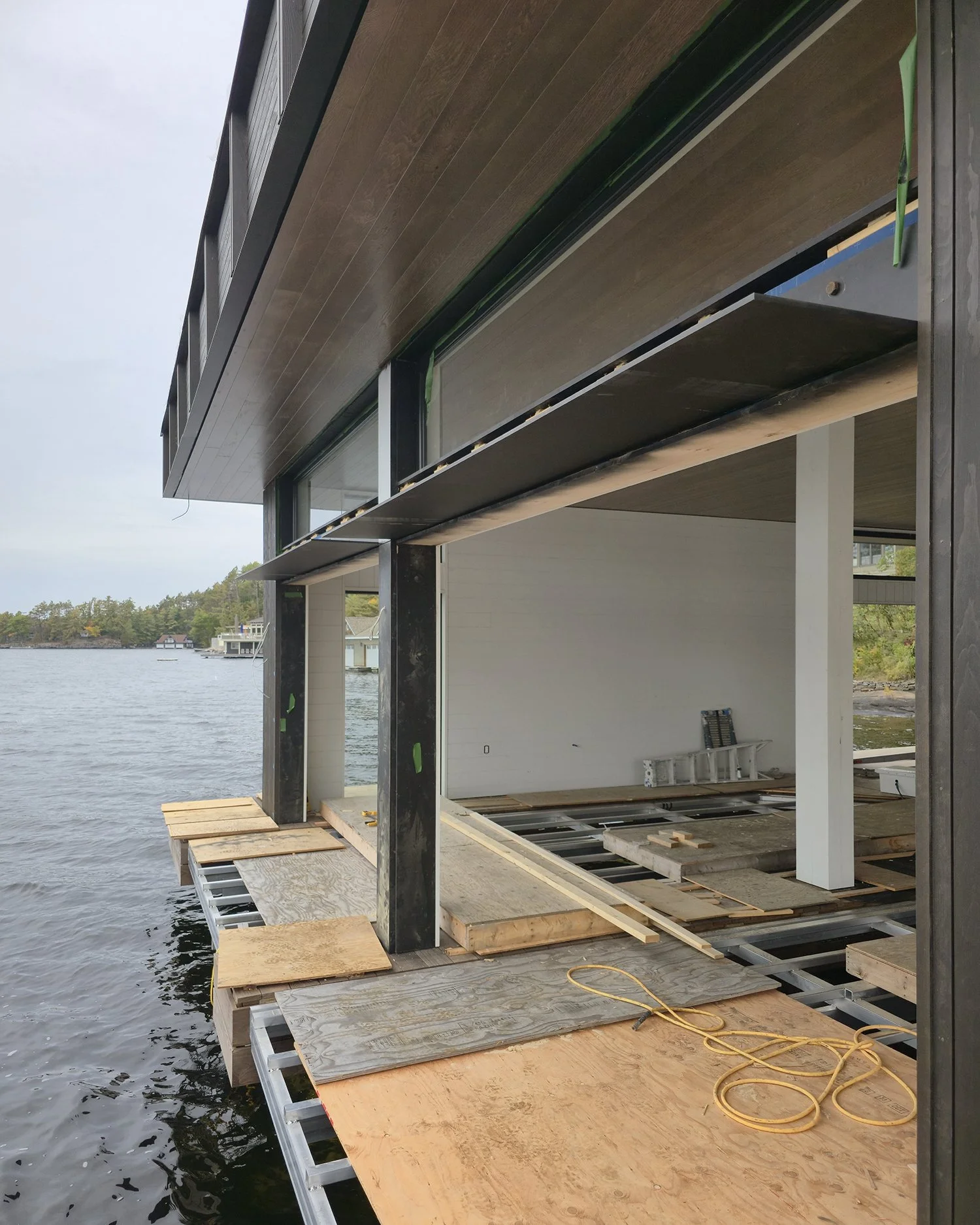 Bedrock Point Boathouse extending from the exposed Canadian Shield shoreline of Lake Muskoka