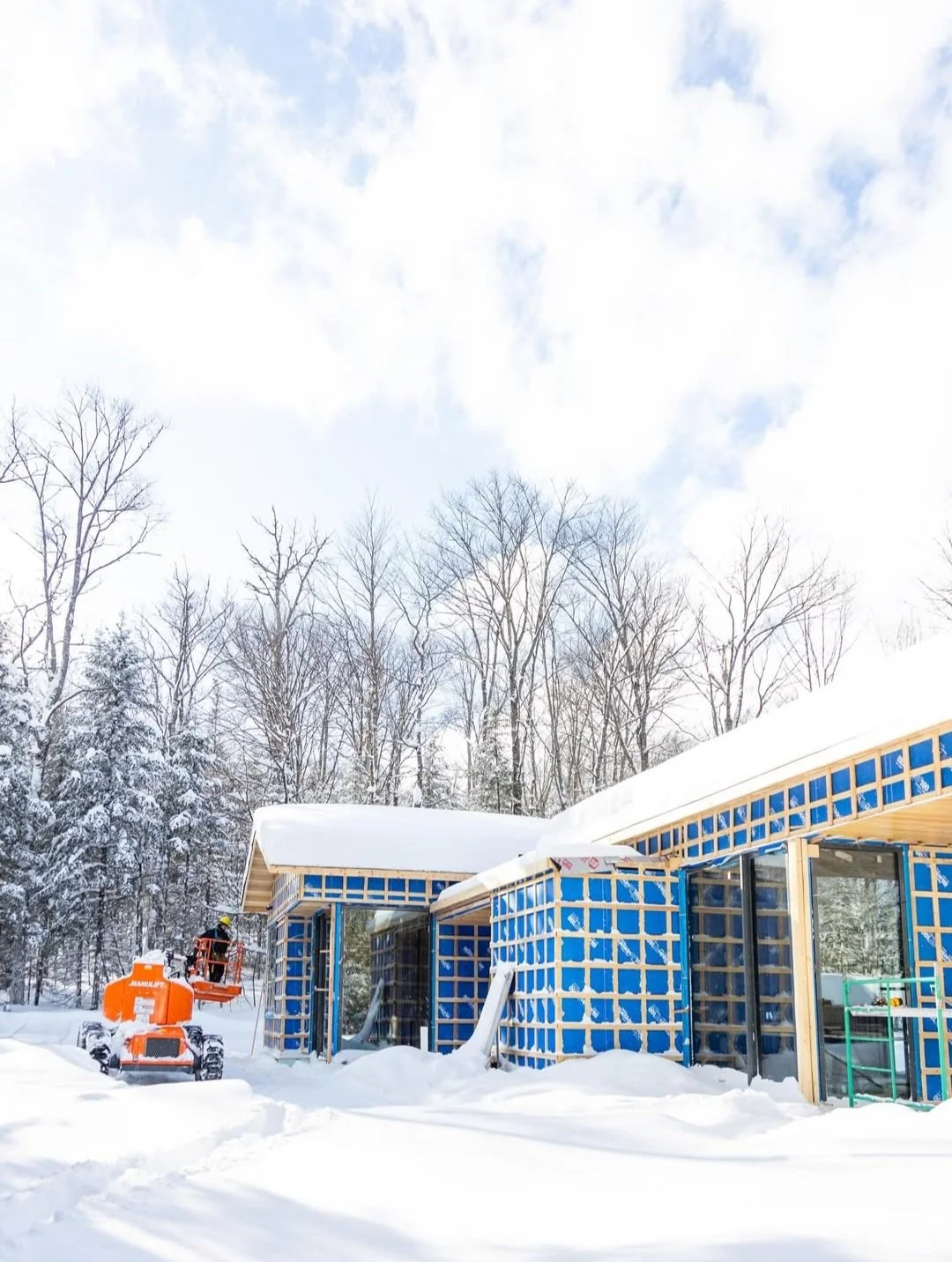 Modern Haliburton Cottage under construction by Daymark, sloped roof, exteiror