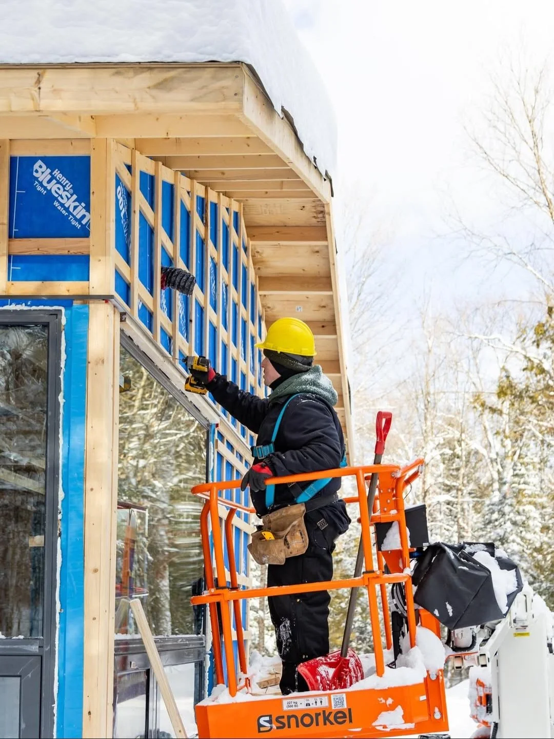 Modern Haliburton Cottage under construction by Daymark, sloped roof, exteiror