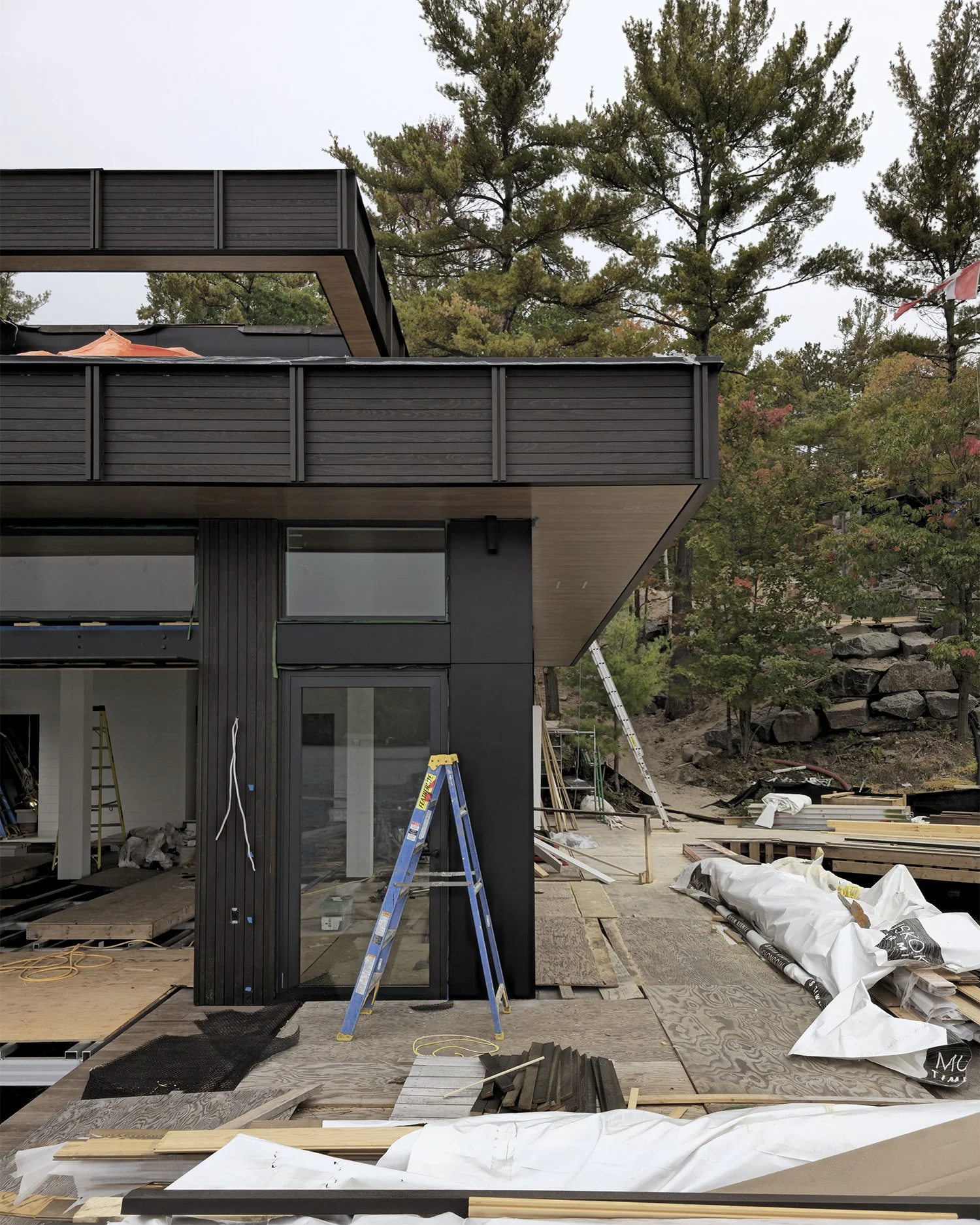 Bedrock Point Boathouse extending from the exposed Canadian Shield shoreline of Lake Muskoka