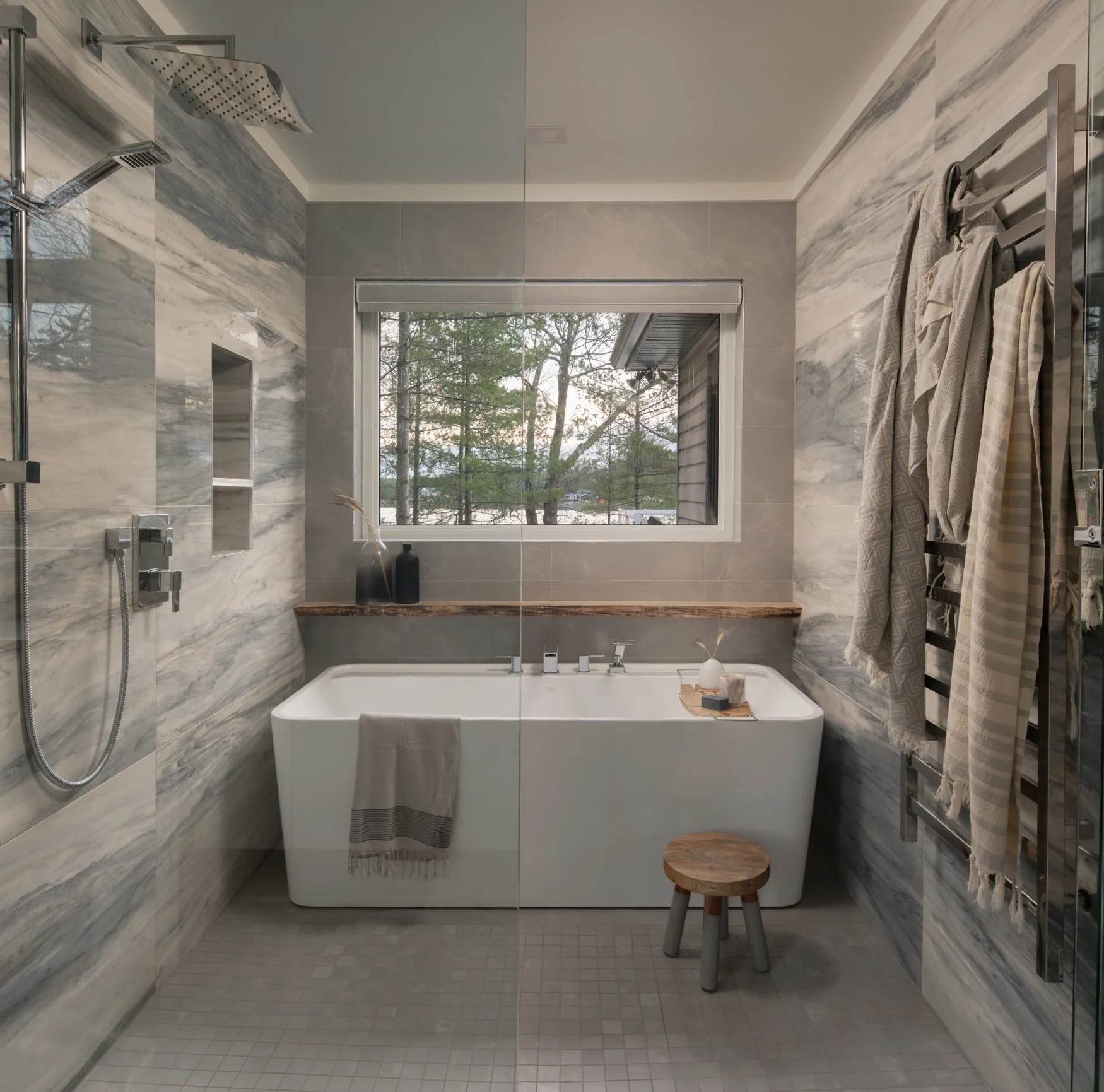 Free standing bathtub in front of window