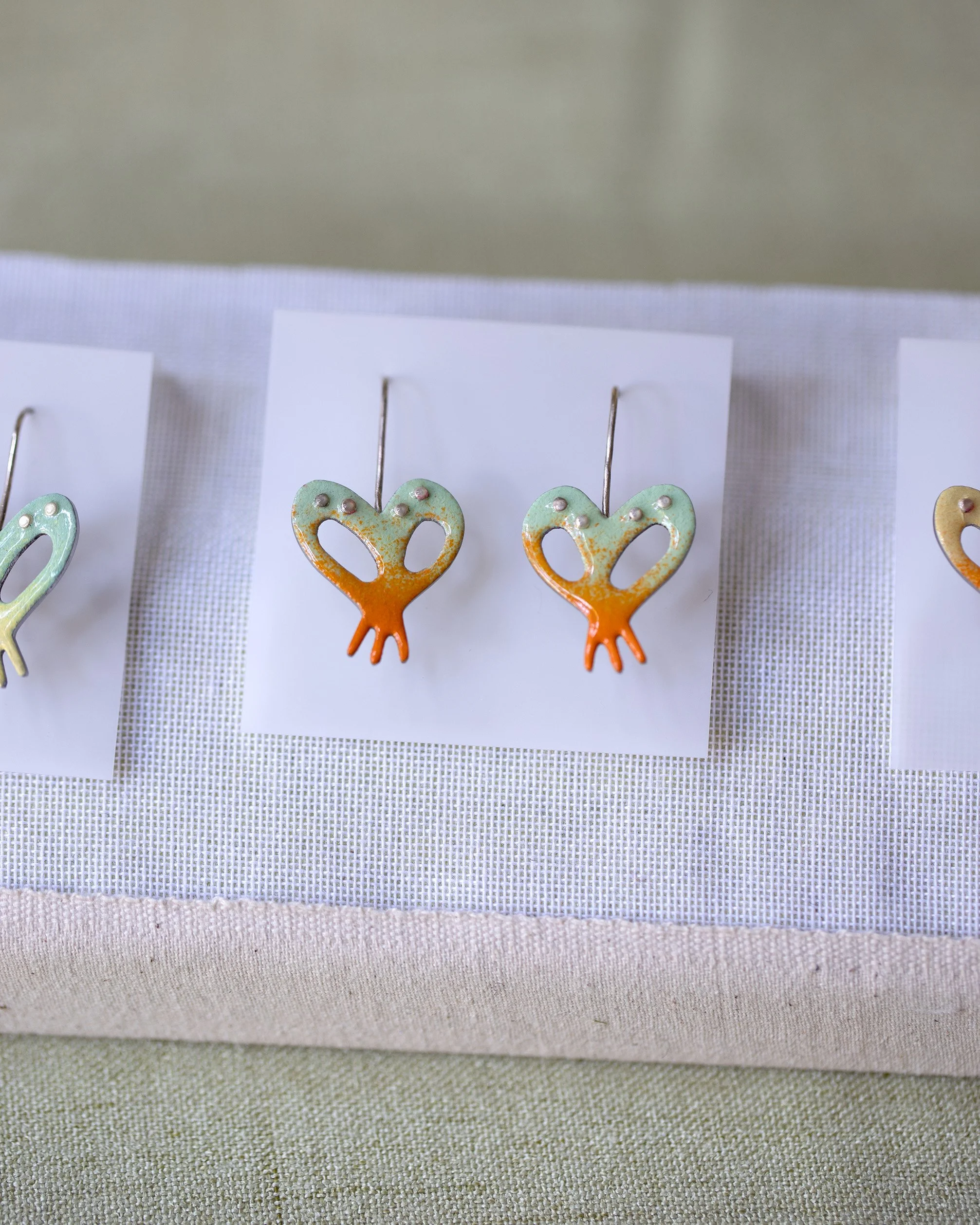 detail of small power coated orchid earrings