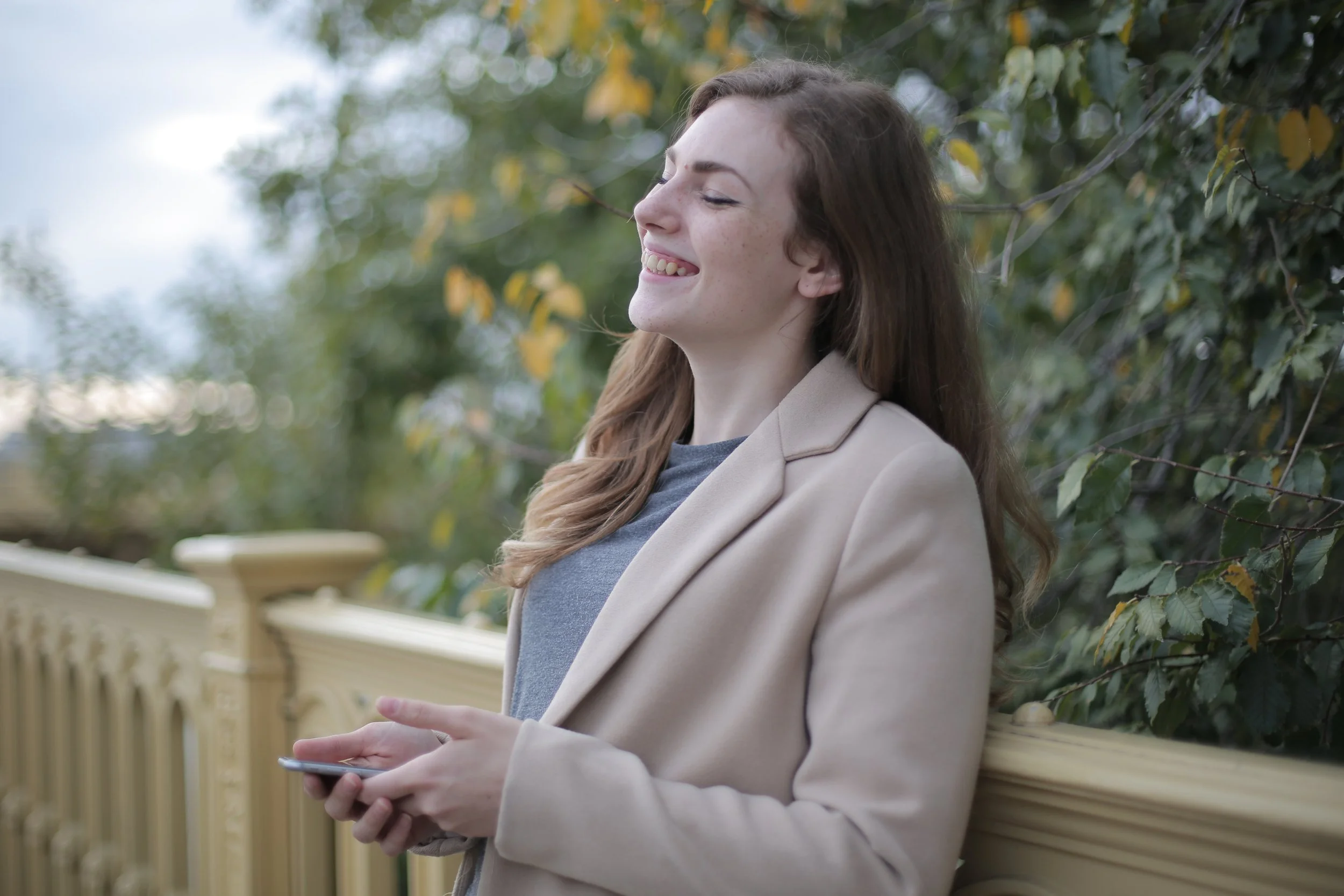 woman laughing outside on deck
