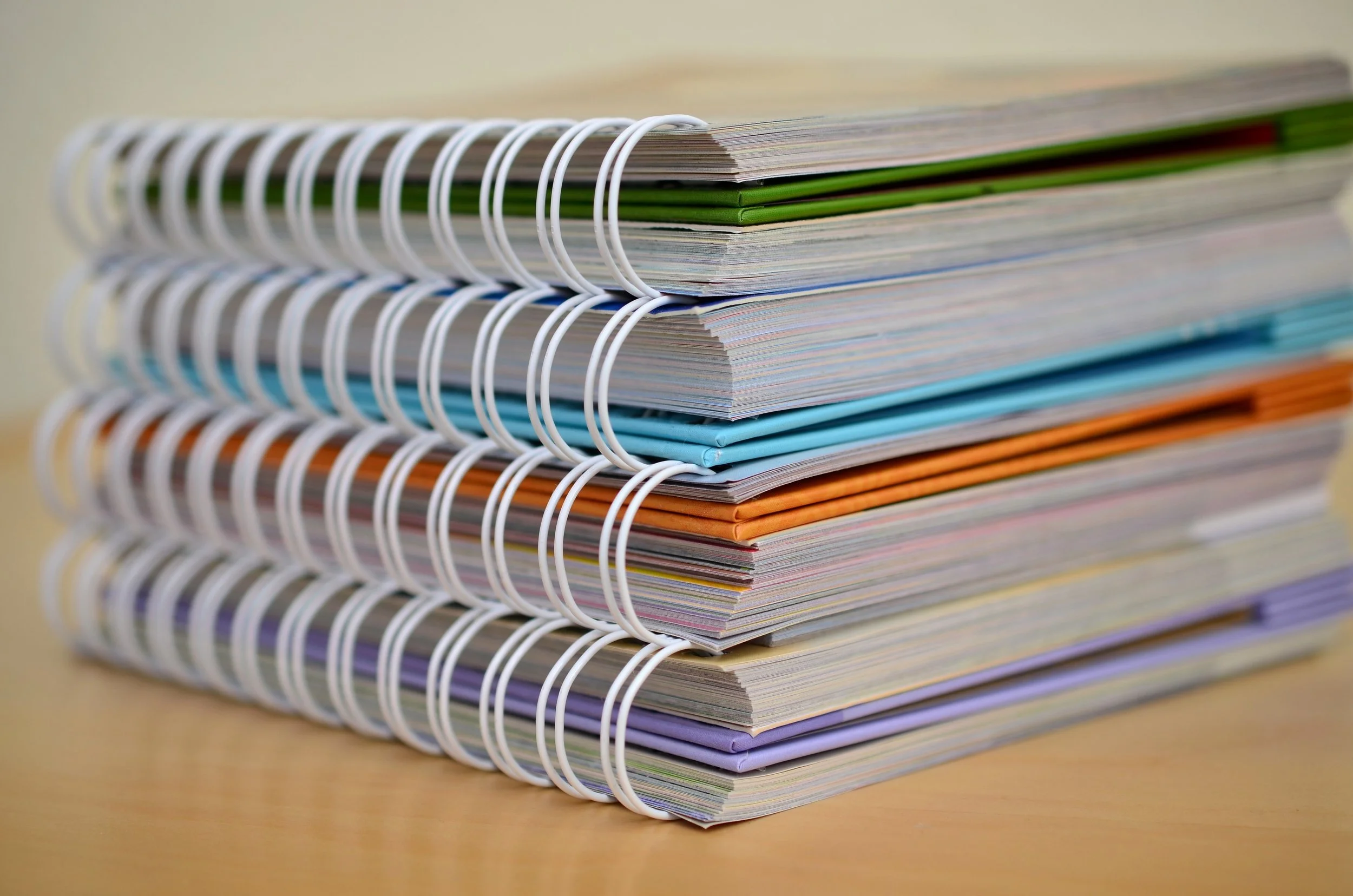 stack of colorful spiral bound notebooks