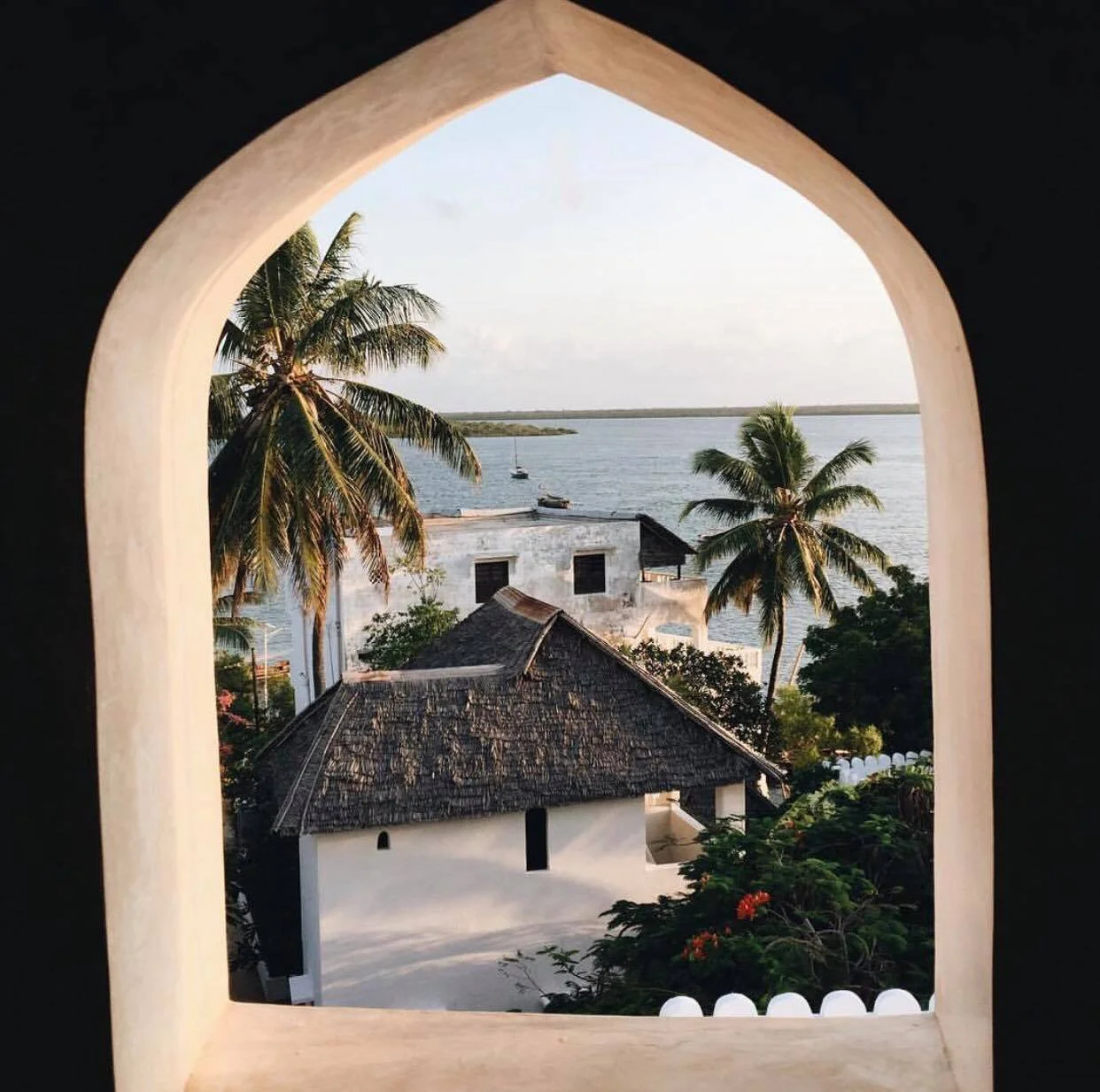 Traditional doorway framing Shela Village in Lamu, Kenya, capturing the timeless architecture and relaxed coastal atmosphere of the Swahili Coast.