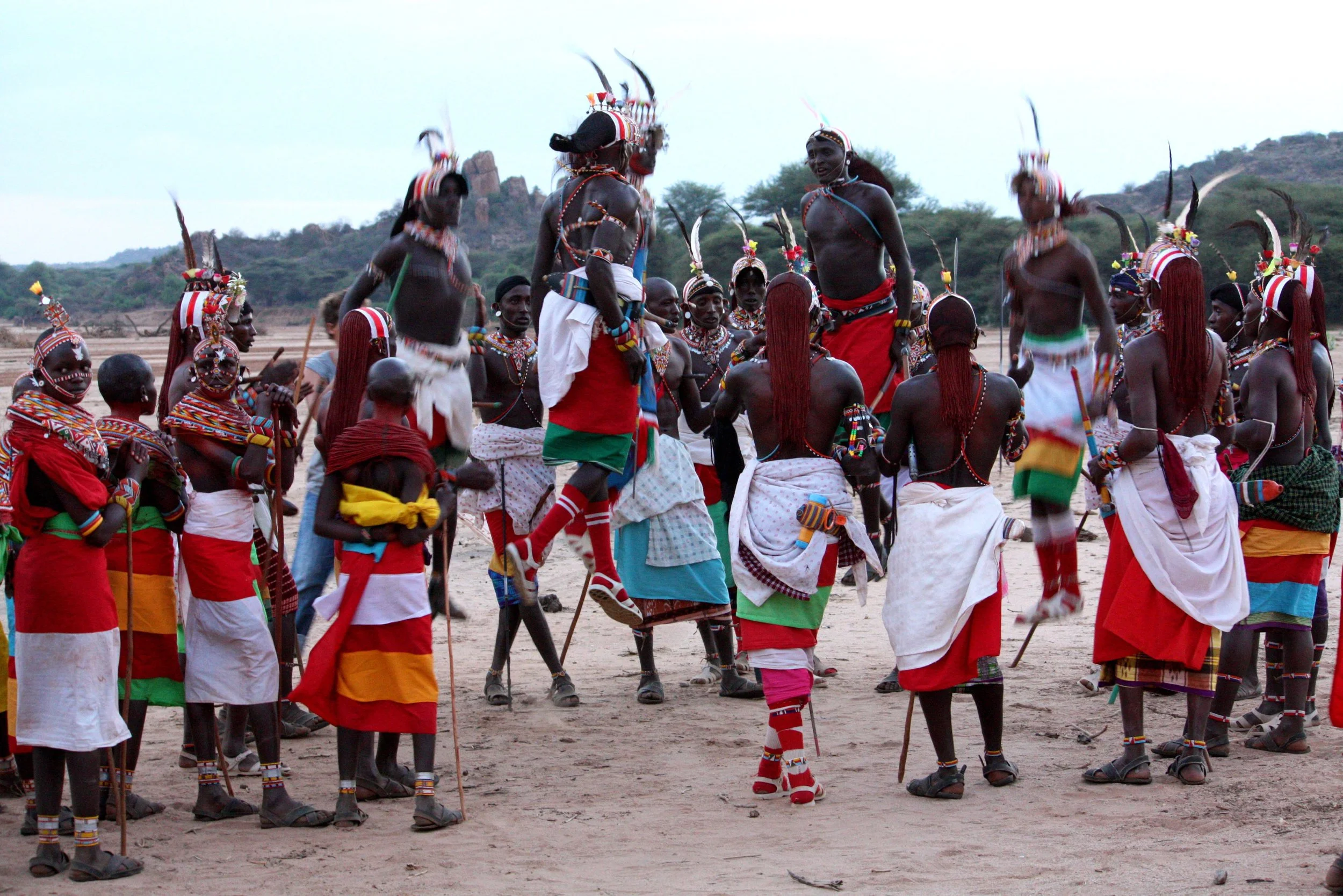 Samburu community members performing a traditional dance in northern Kenya, sharing East African culture with guests on a North Node Journeys safari