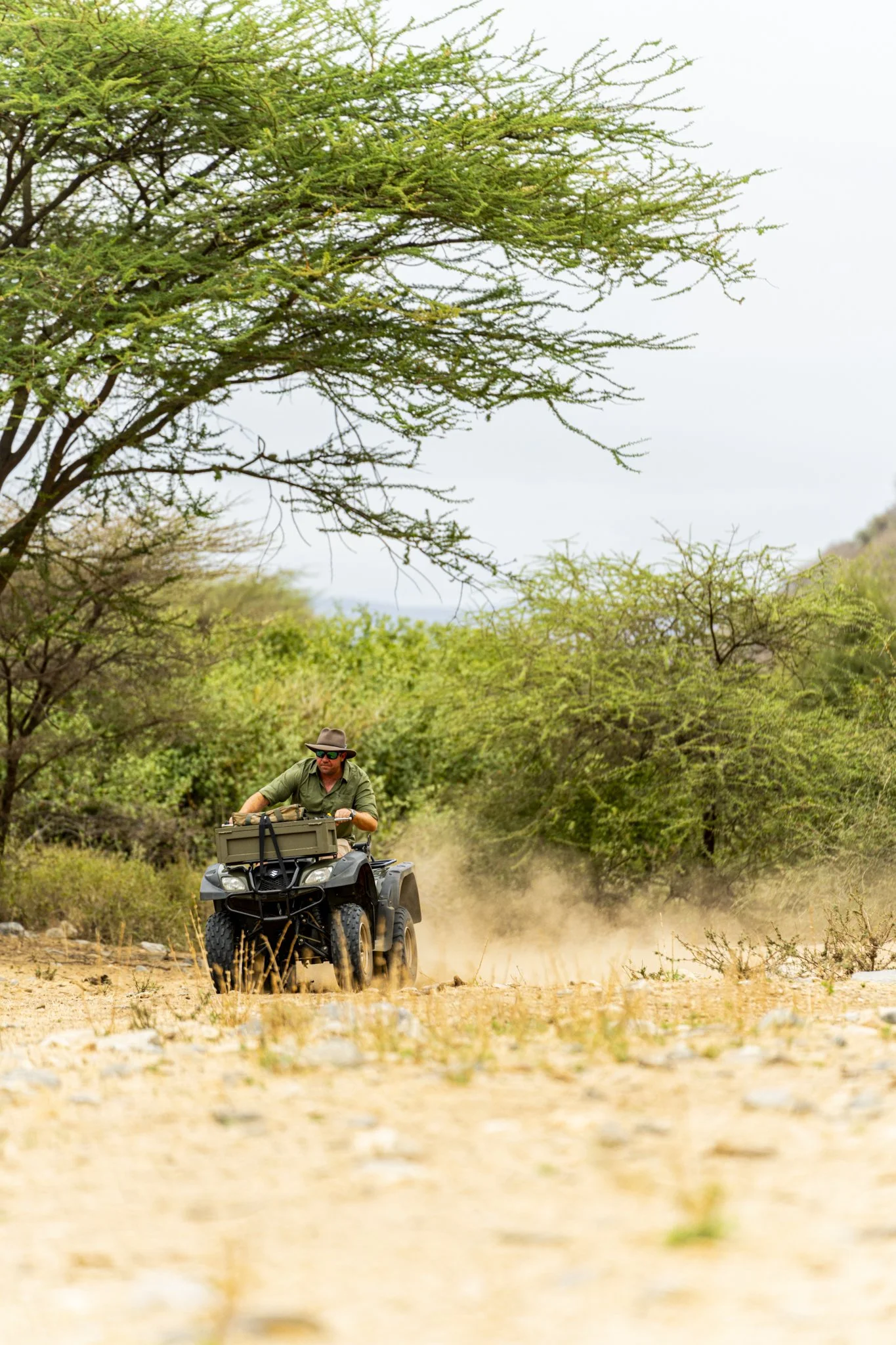 Guests exploring the remote landscapes of northern Kenya by quad bike near Koros Camp, experiencing an off-road adventure through East Africa's Northern Frontier.